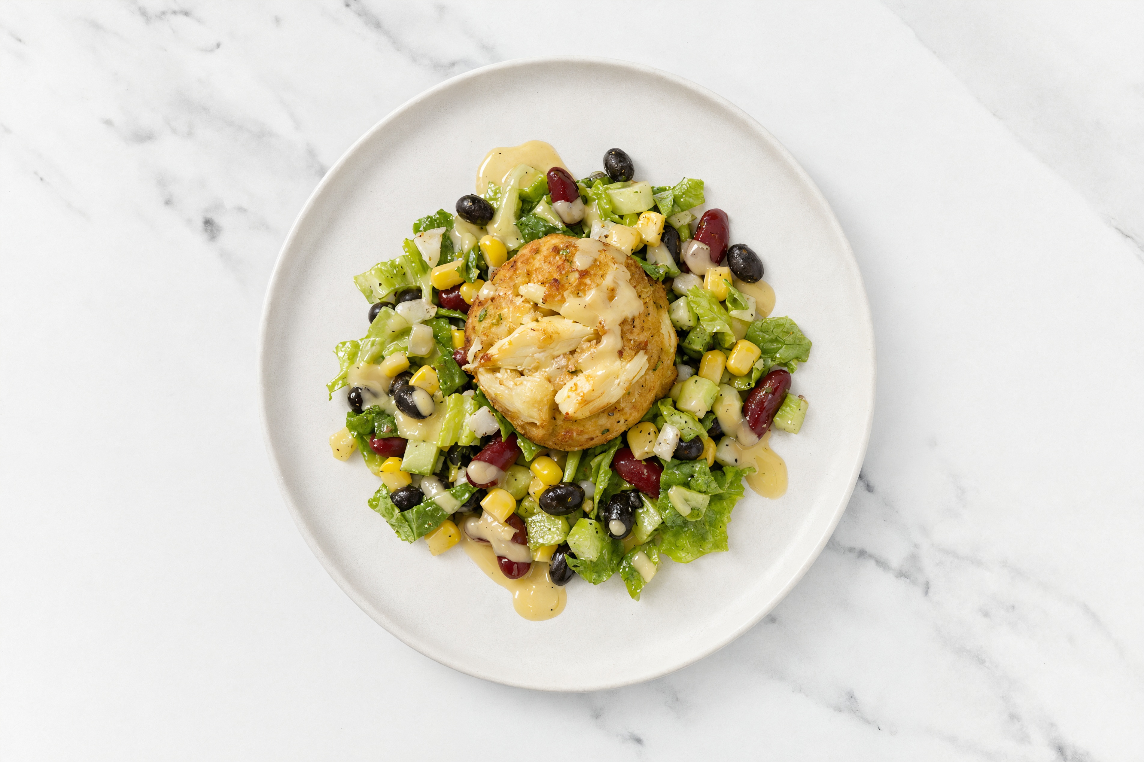 Jumbo Lump Crab Cakes Cake on Romaine + Bean Salad