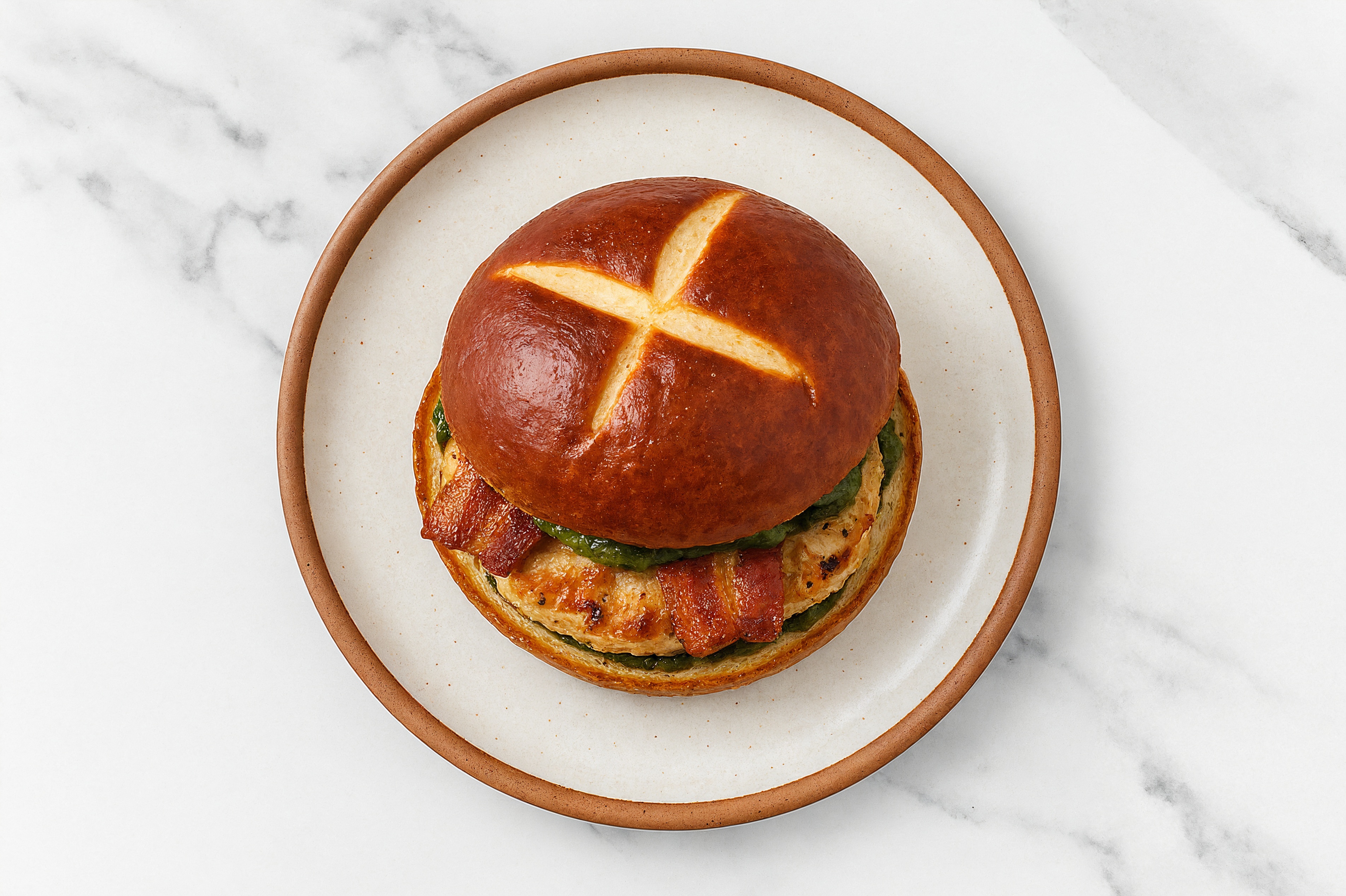 Garlic Chicken Burger on Pretzel with Spinach Pesto & Applewood Smoked Pork Bacon