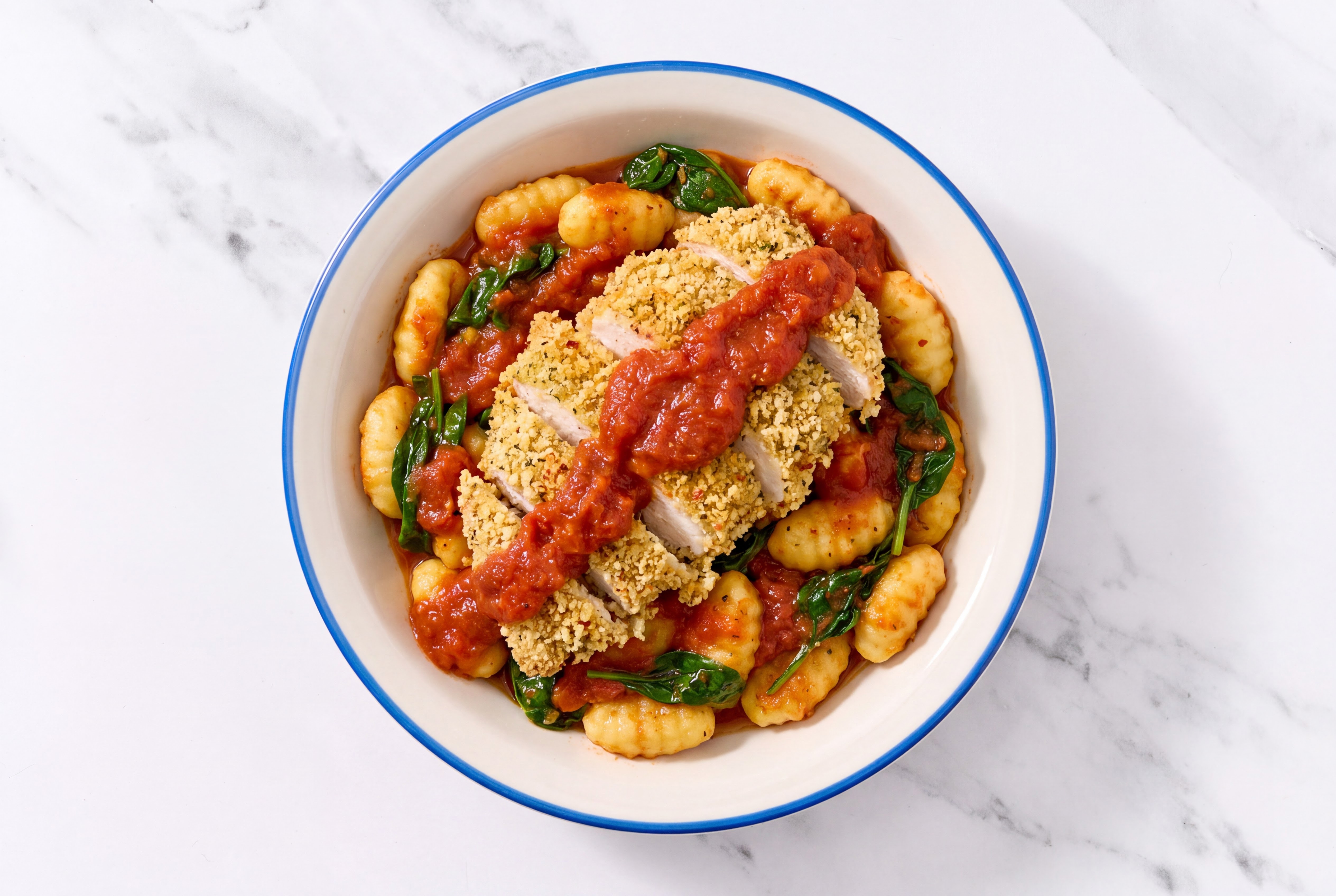 Crispy Garlic Chicken over Marinara Gnocchi with Baby Spinach