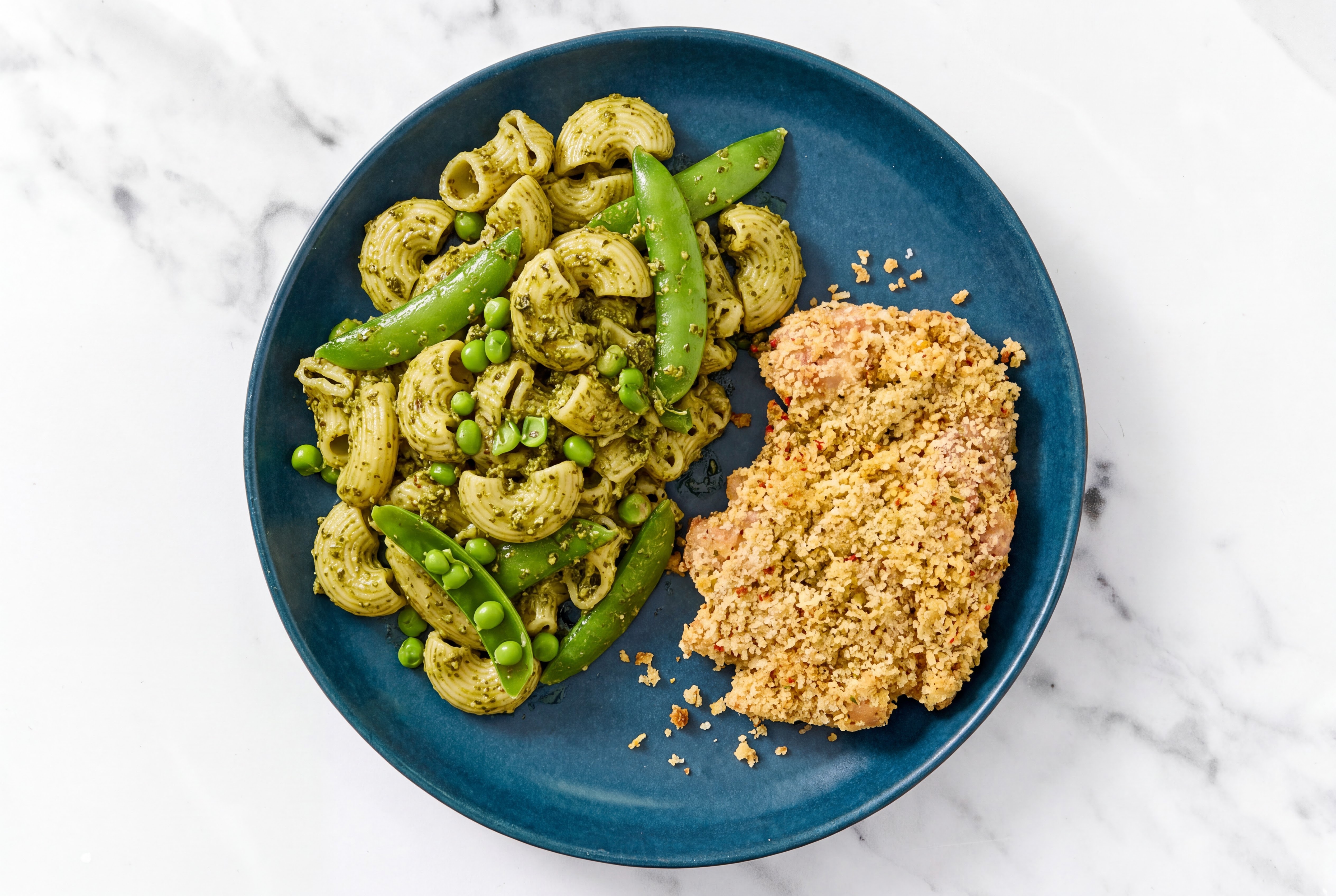 Crispy Garlic Chicken over Pesto Chiocciole Pasta with Snap Peas