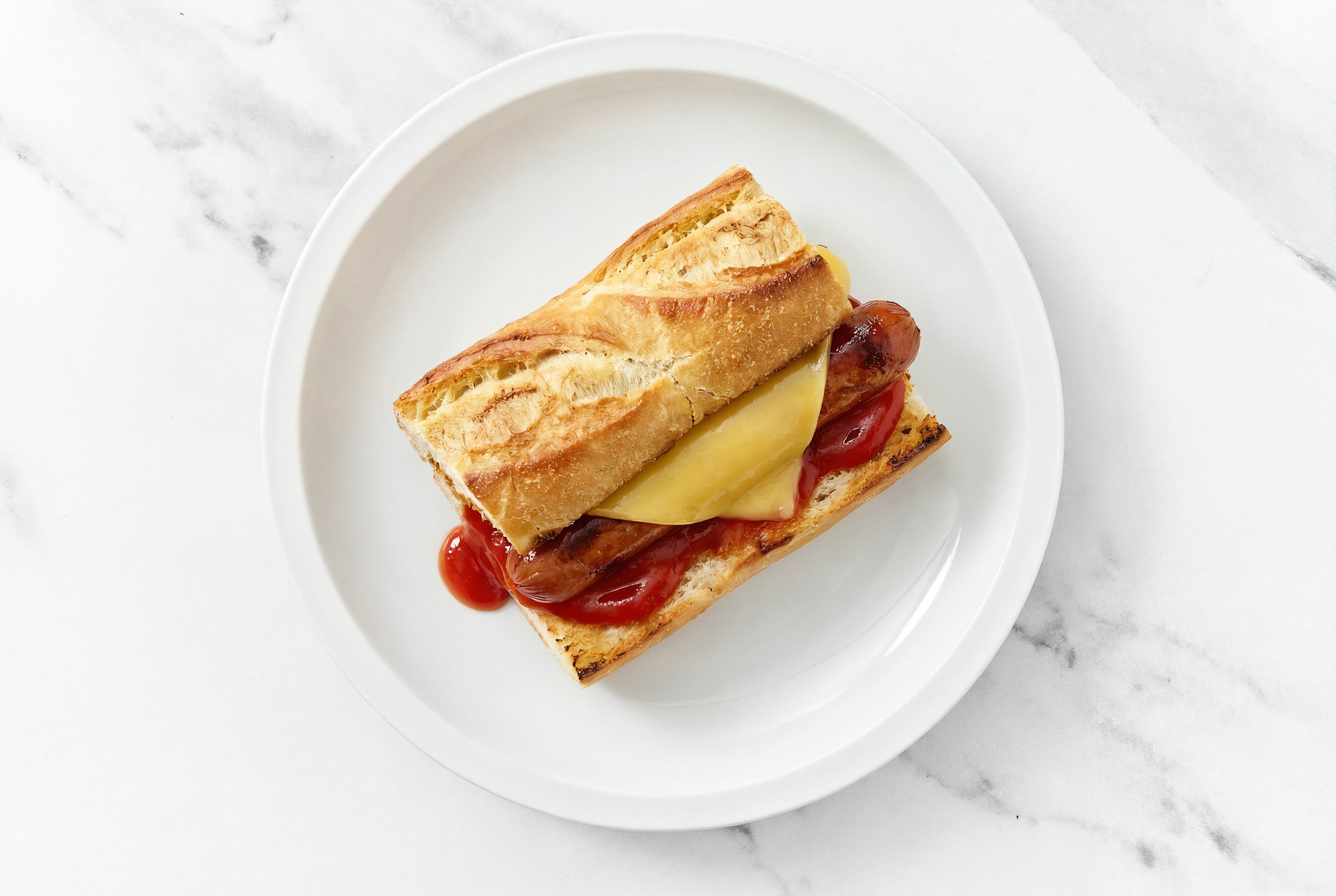 Vegan Cheddar Beef Hot Dog with Ketchup on Baguette