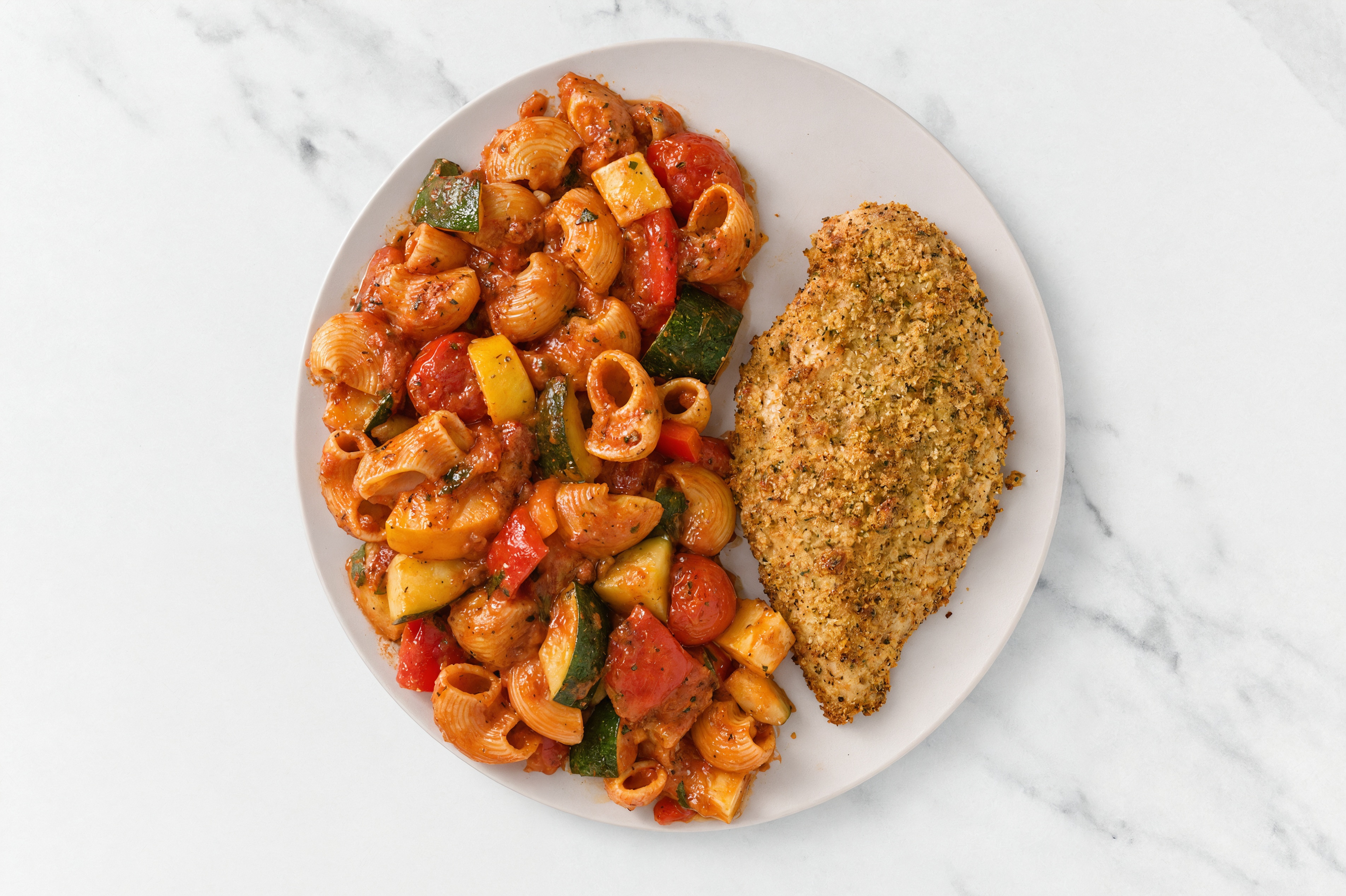 Crispy Garlic Chicken over Marinara Chiocciole Pasta with Mixed Veggies