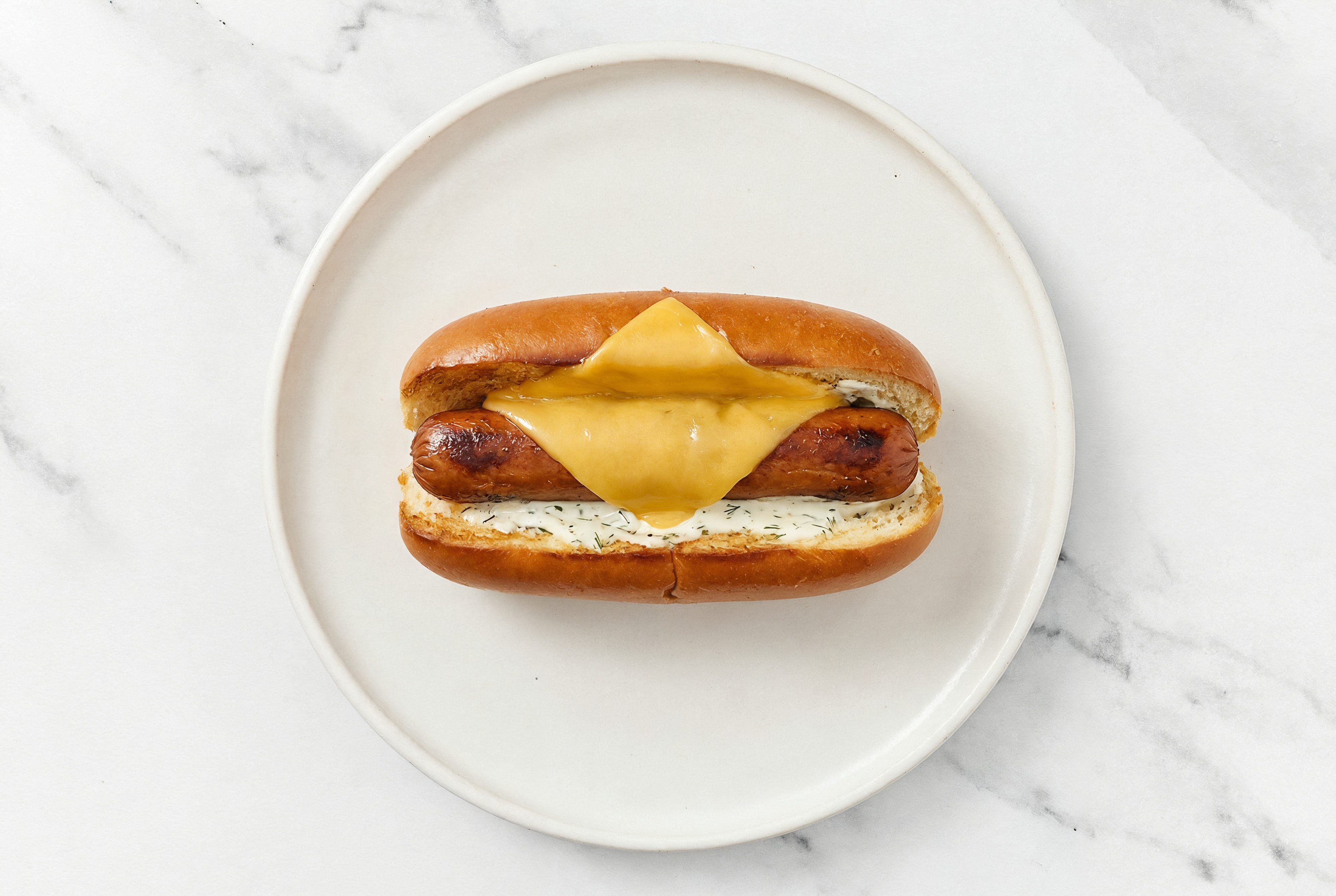 Vegan Cheddar Smart Dog with Garlic Sauce on Brioche