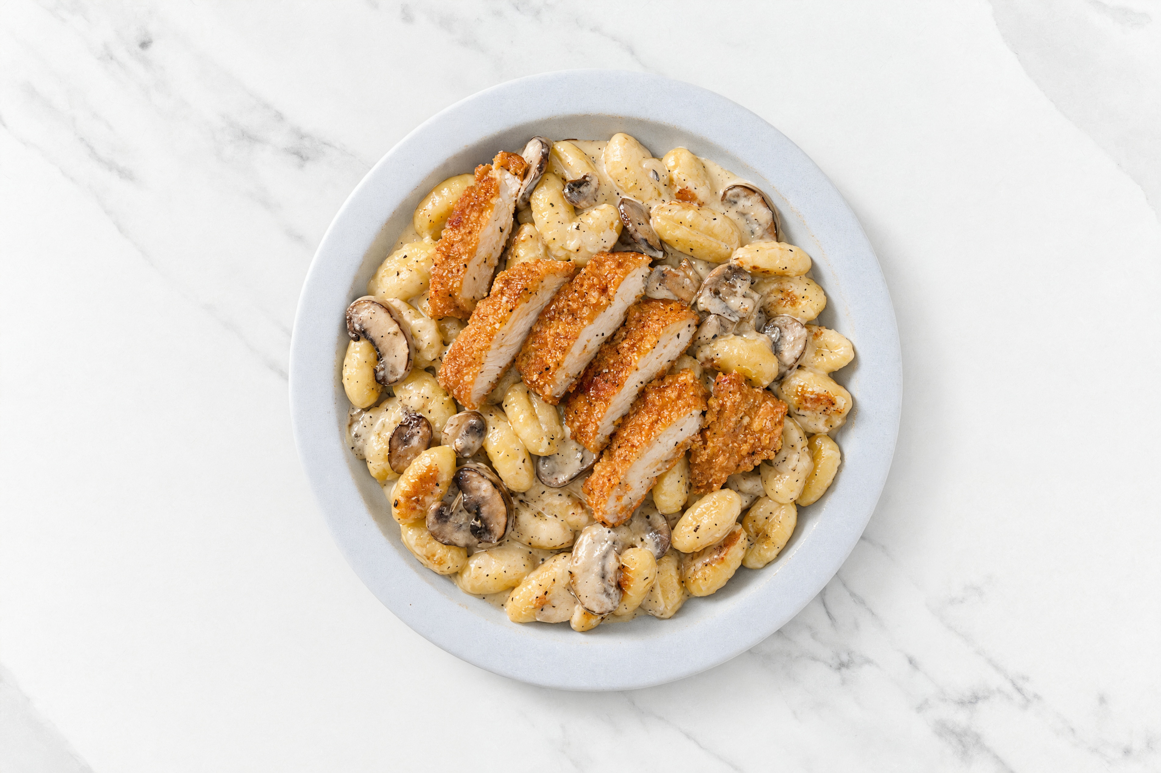 Crispy Hot Honey Chicken over Alfredo Gnocchi with Baby Bella Mushrooms
