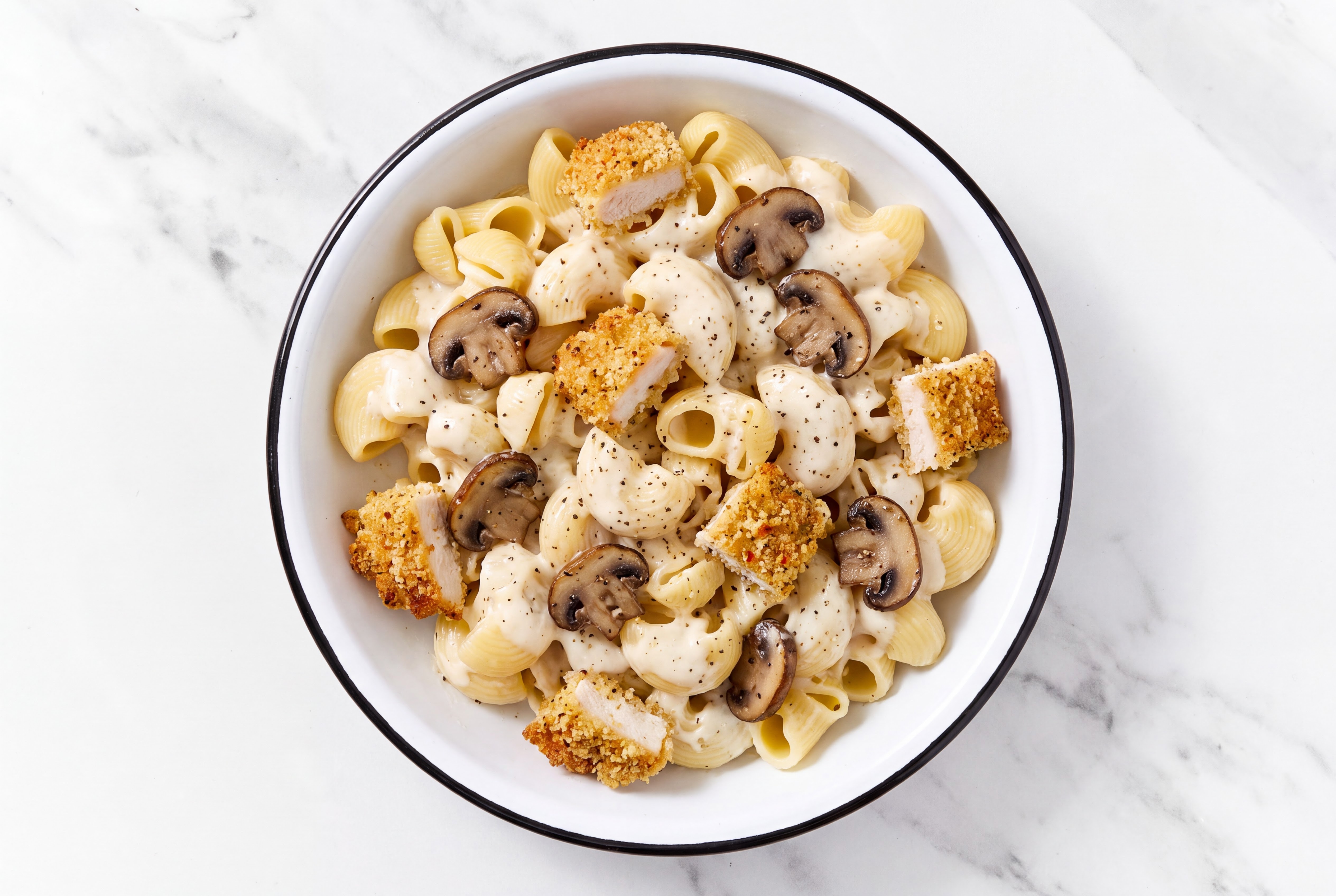 Crispy Garlic Chicken over Alfredo Chiocciole Pasta with Baby Bella Mushrooms