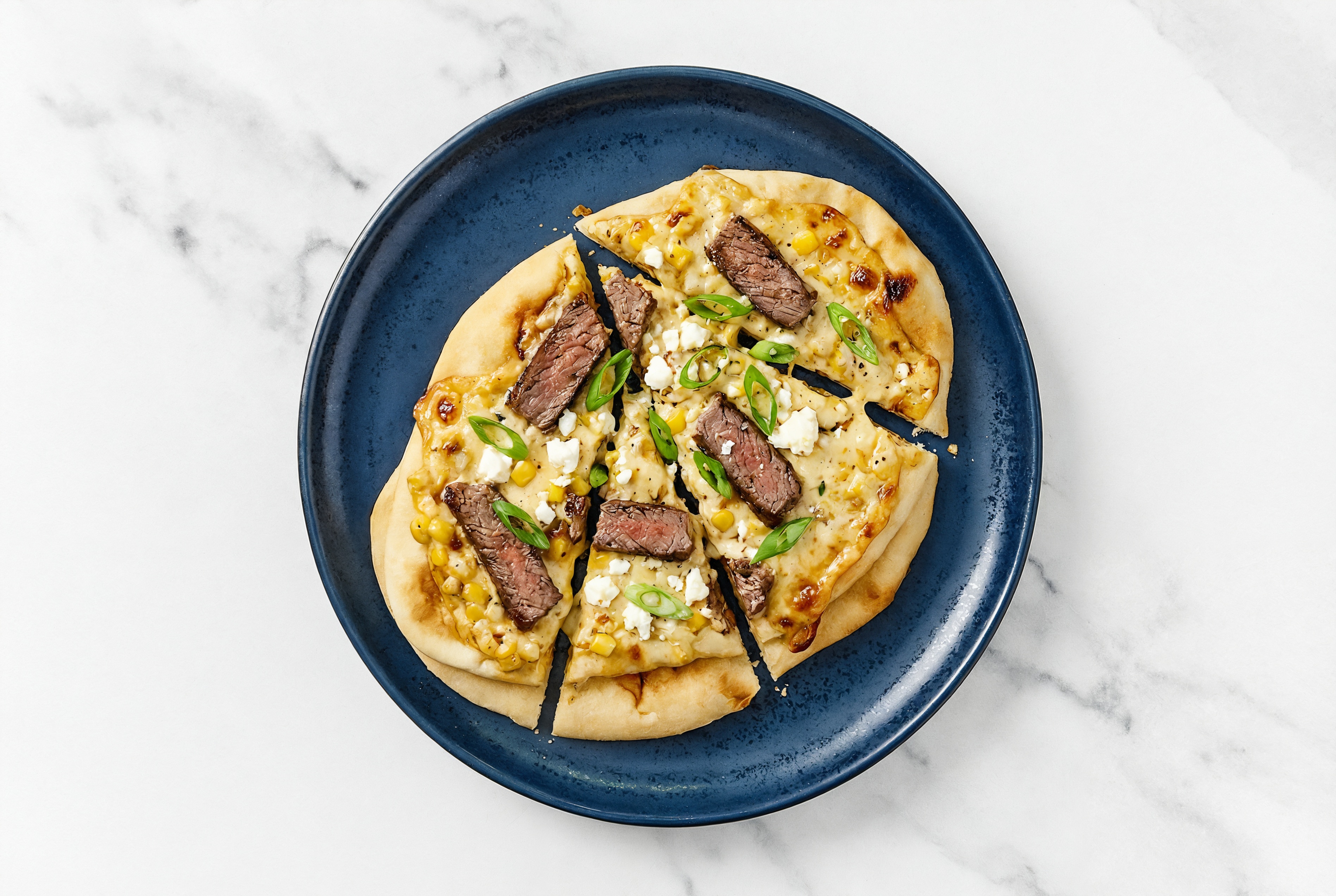 Street Corn Wagyu Strip Naan Pizza with Sheep Cheese + Fresh Scallions