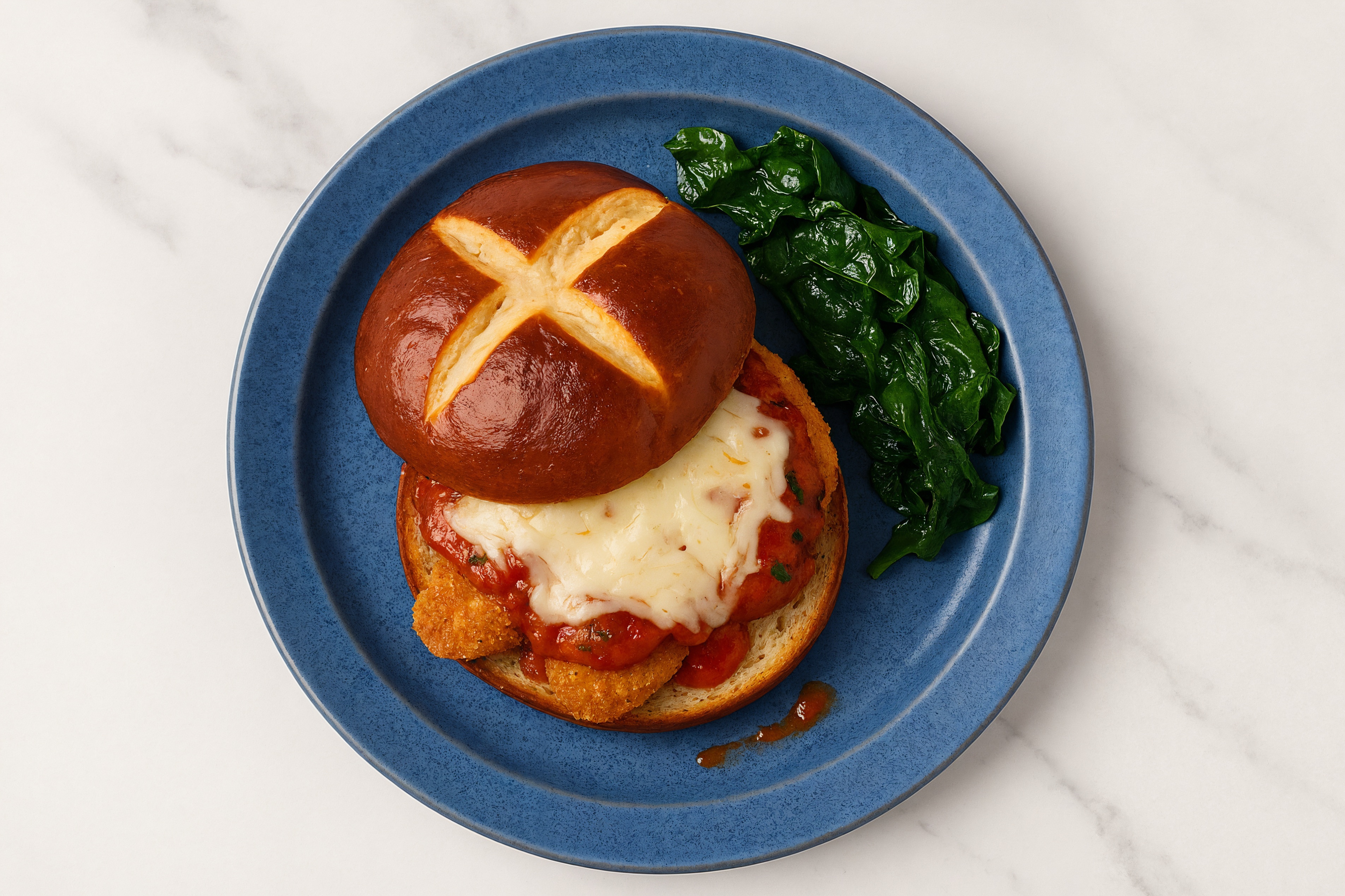 Chick'n Parm Sandwich on Pretzel Bun with Baby Spinach