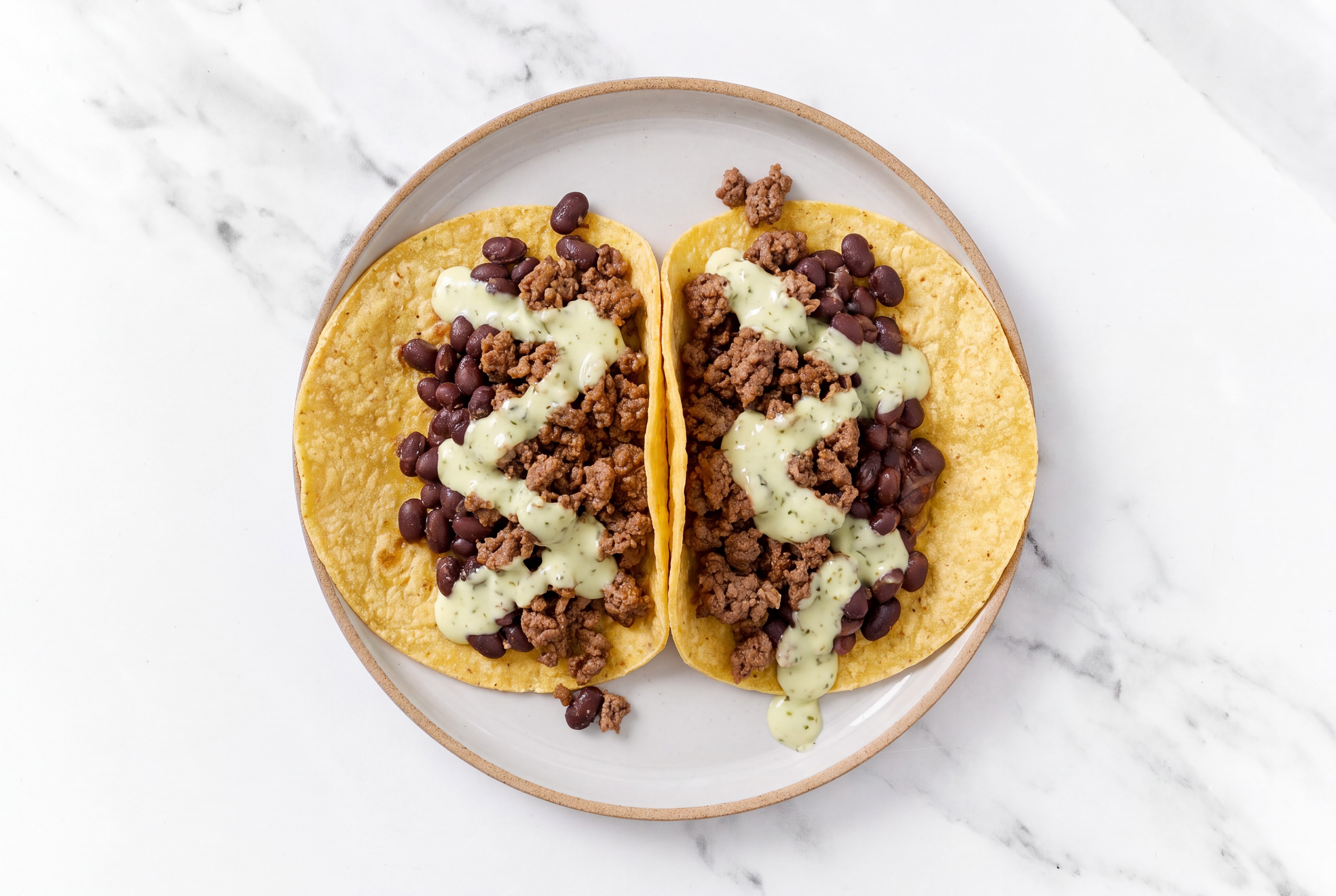 Herby Ground 93/7 Lean Beef Tacos with Jalapeño Crema & Spiced Beans