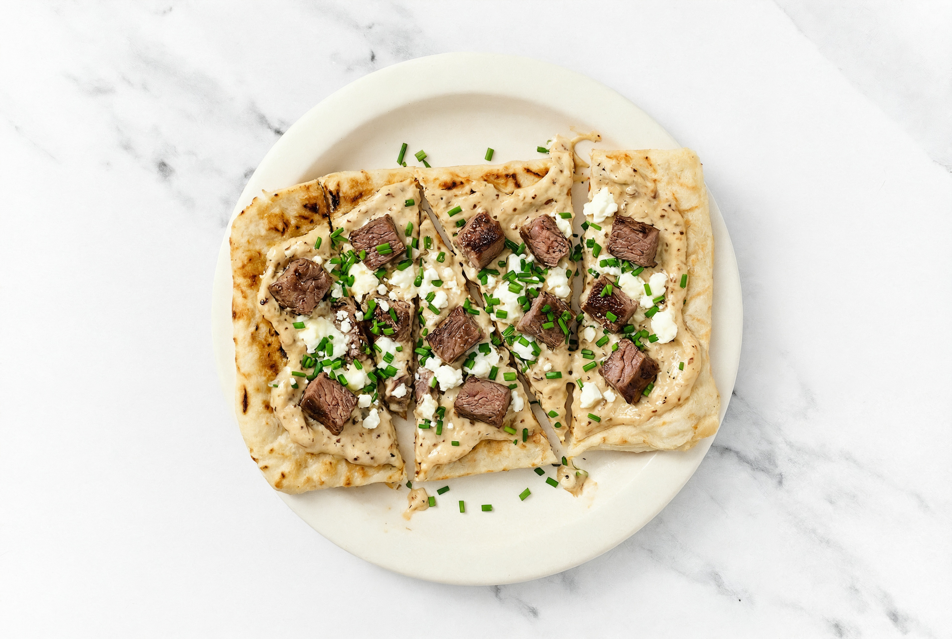 Sweet Onion Wagyu Strip Grilled Pizza with Sheep Cheese + Fresh Chives