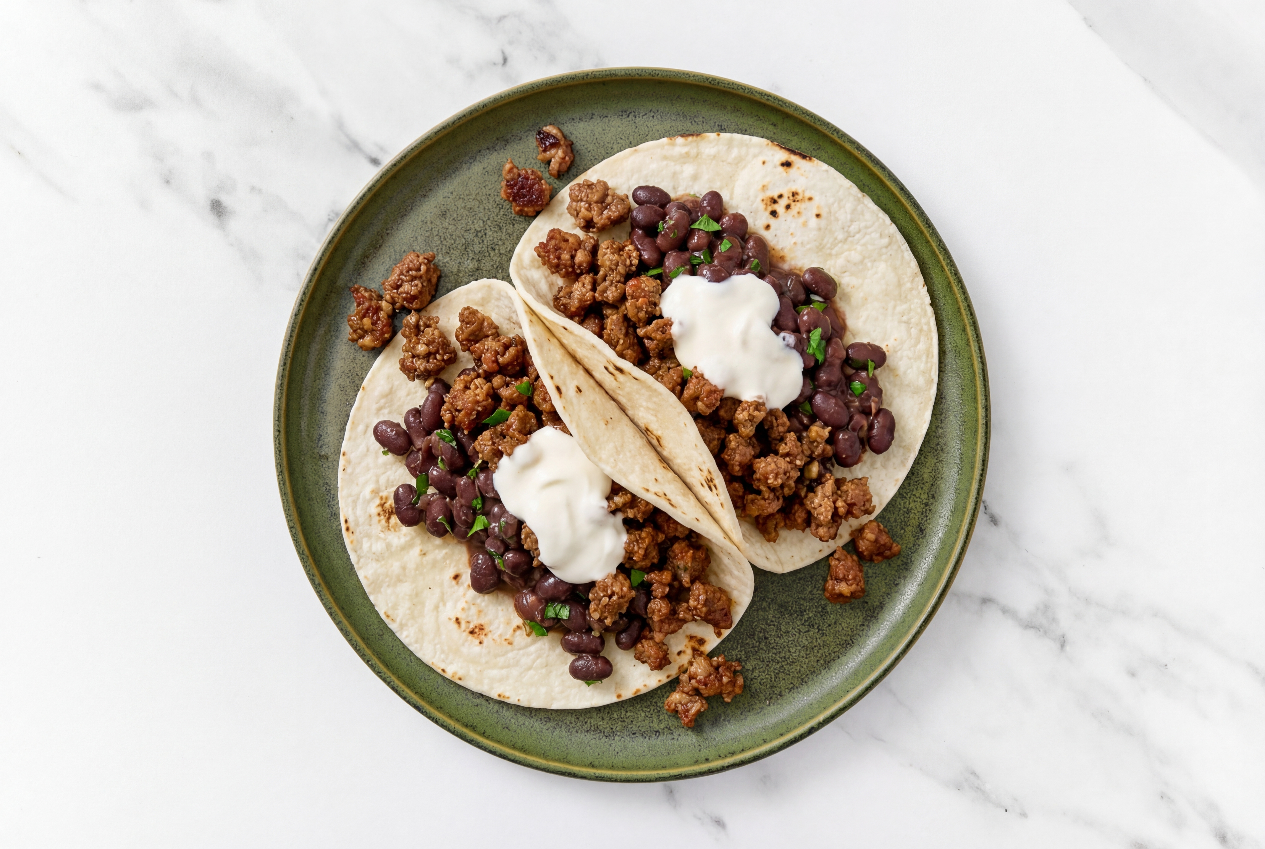 Hearty Mexican-Style Ground Beef Tacos with Crema & Spiced Beans