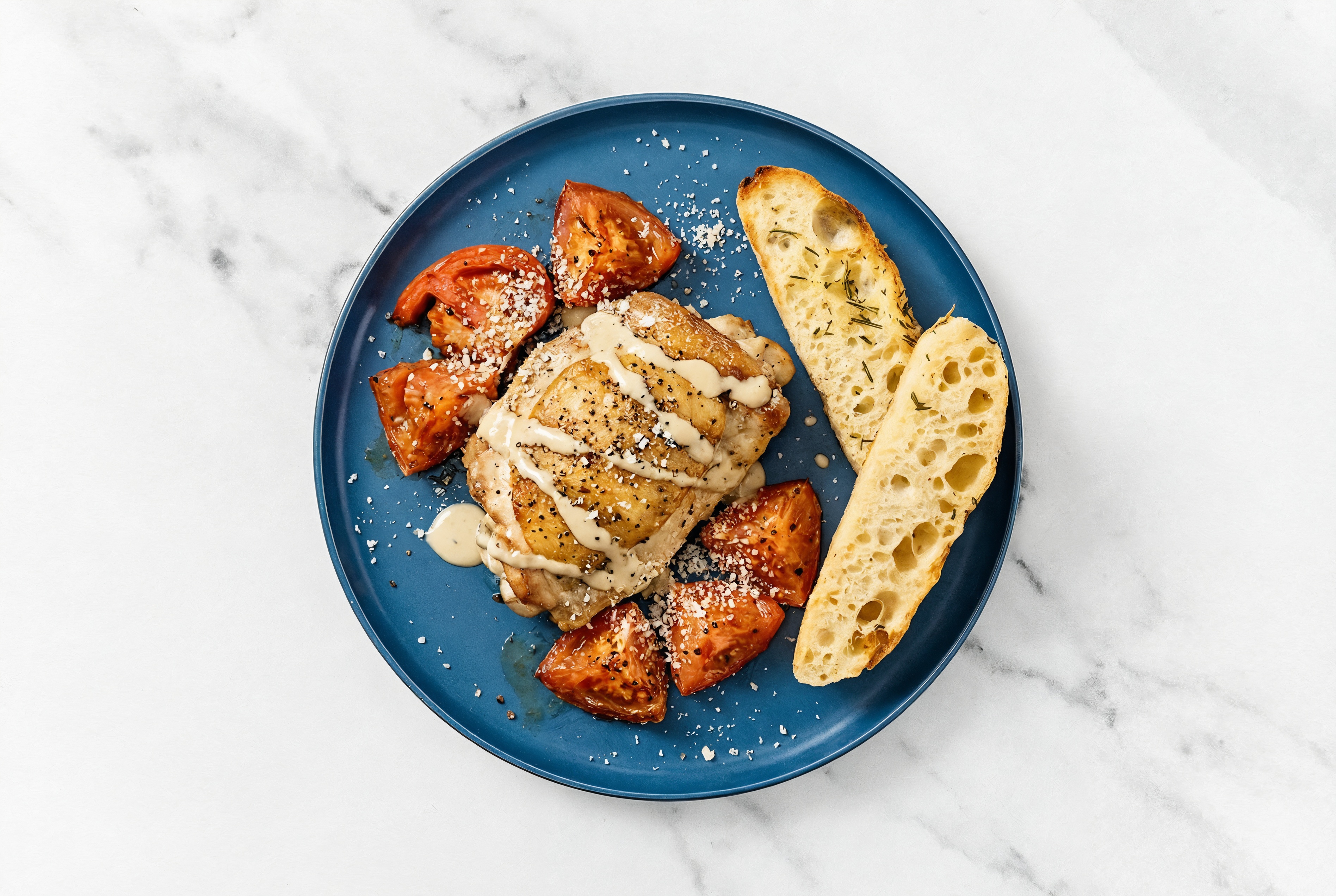 Tomato Tahini Chicken Thighs + Rosemary Focaccia with Grated Parmesan Cheese