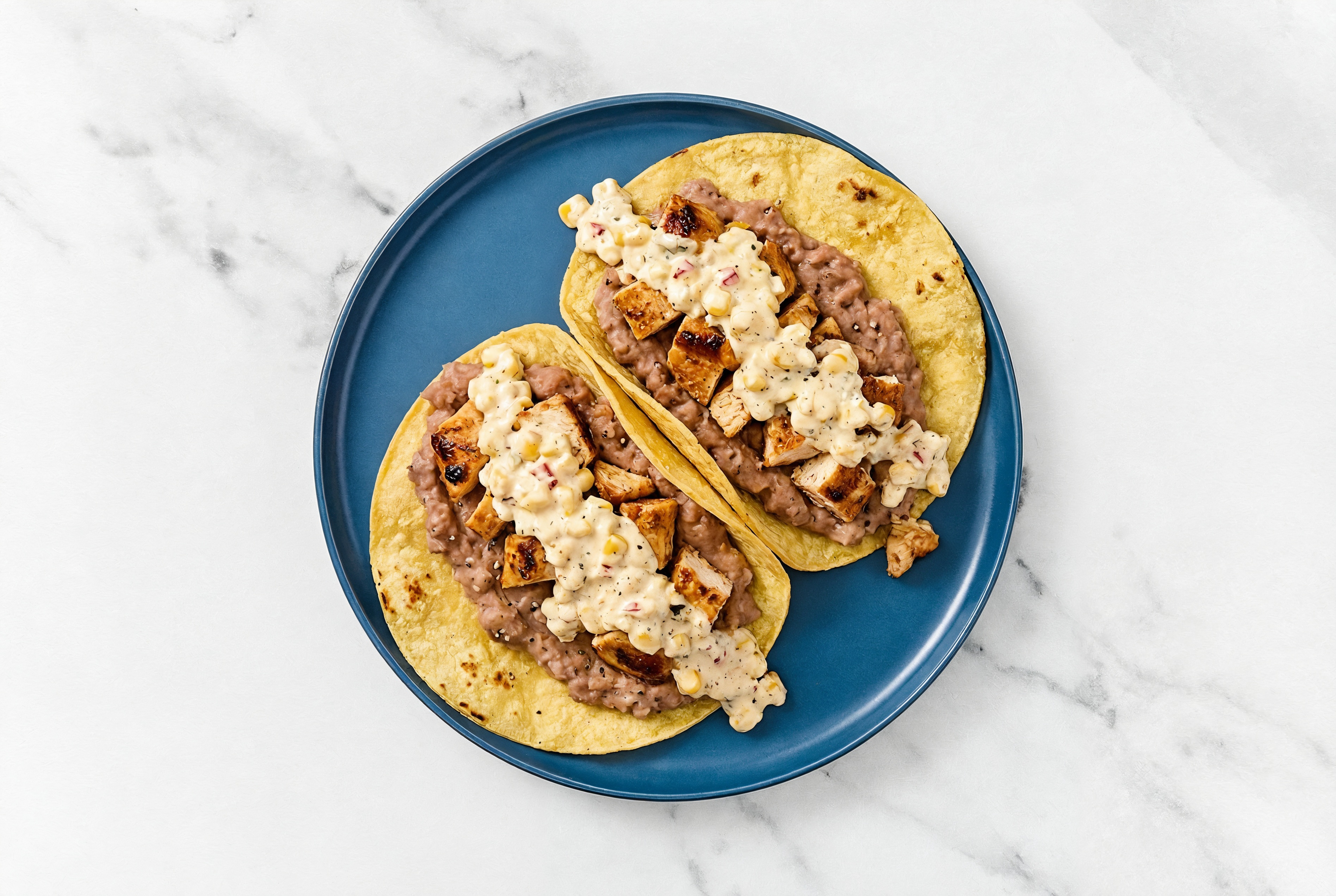 Chipotle Chicken Tacos with Street Corn + Wheat Tortillas Sauce & Refried Red Beans