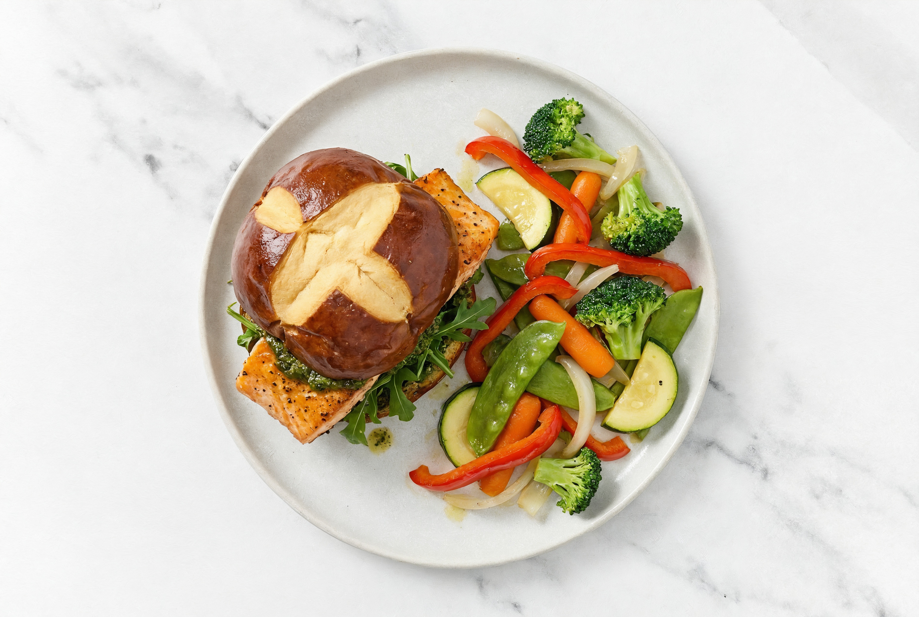 Pesto Salmon Sandwich on Pretzel Bun with Arugula + Mixed Veggies