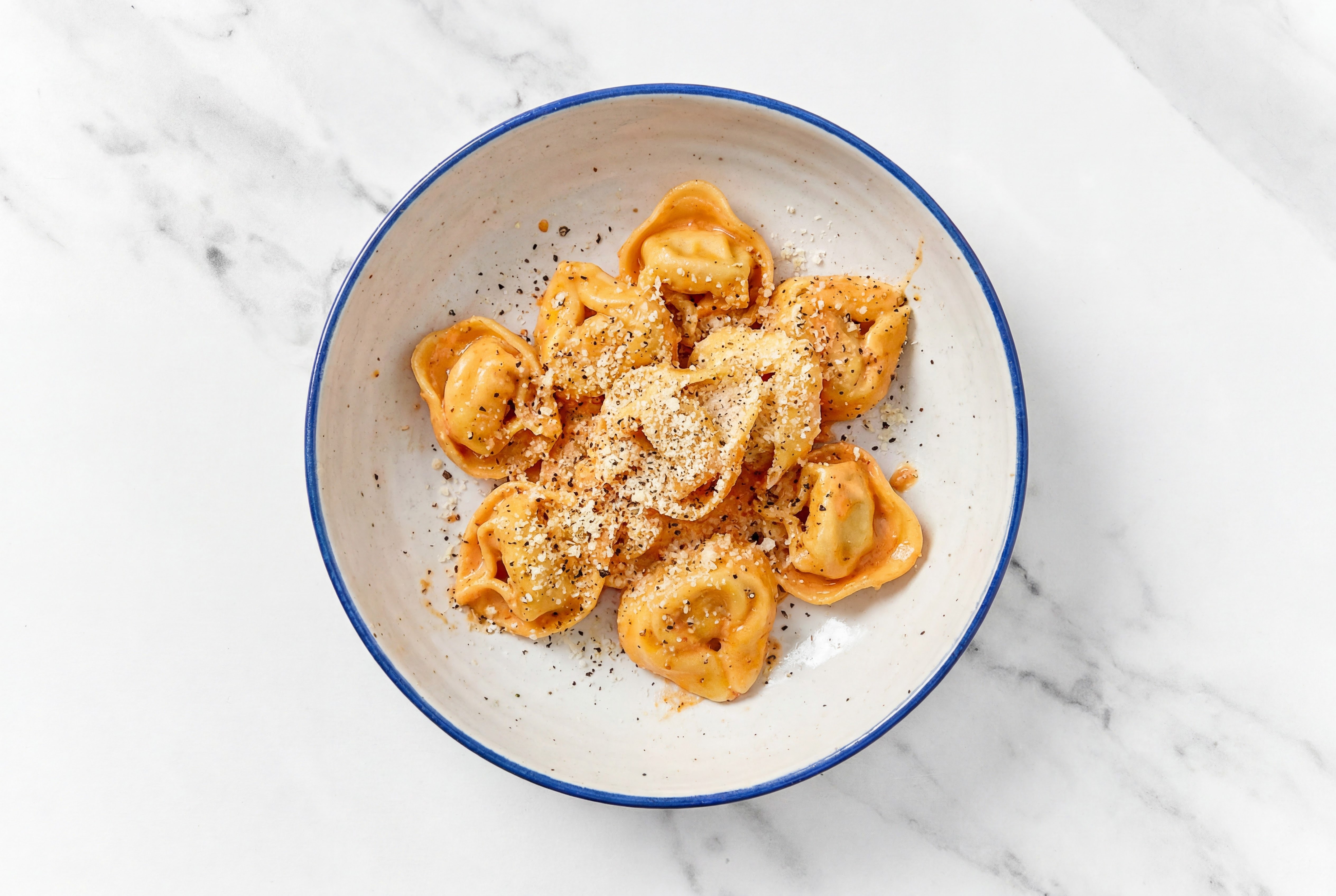 Red Sauce Cheese Tortelloni with Grated Parmesan Cheese