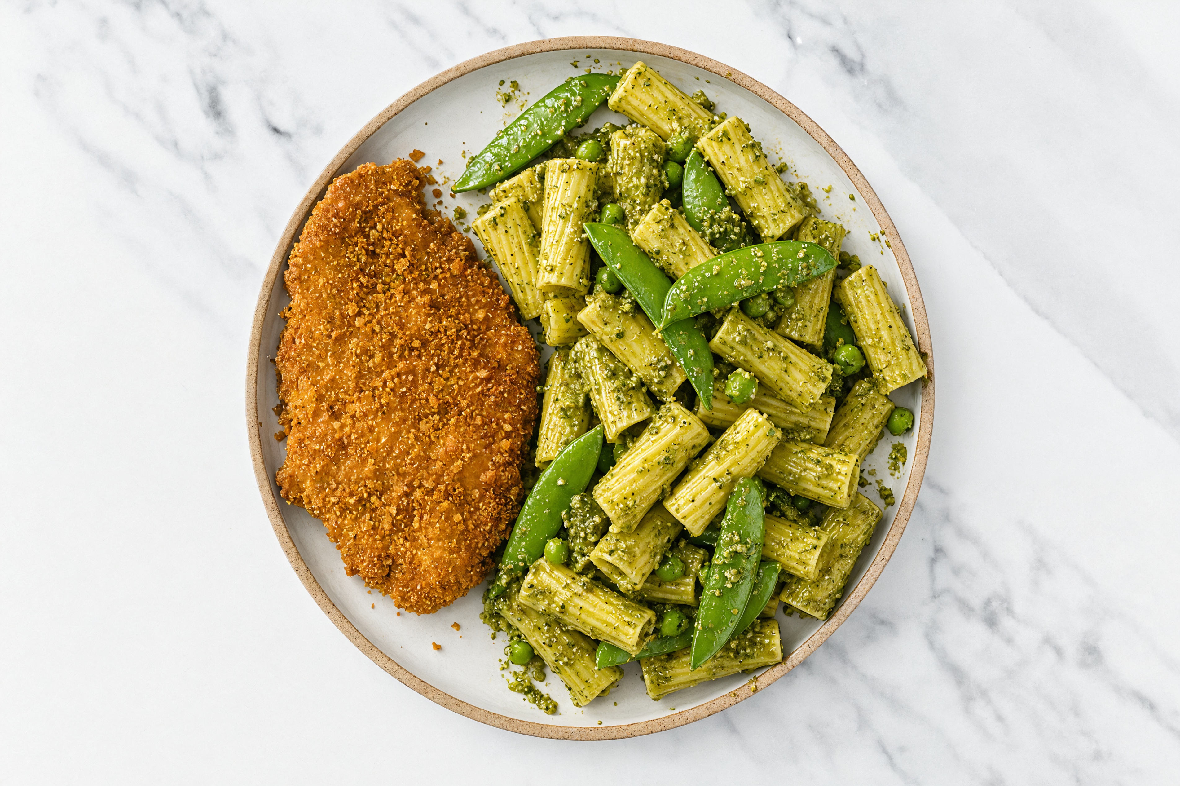 Crispy Hot Honey Chicken over Pesto Rigatoni with Snap Peas