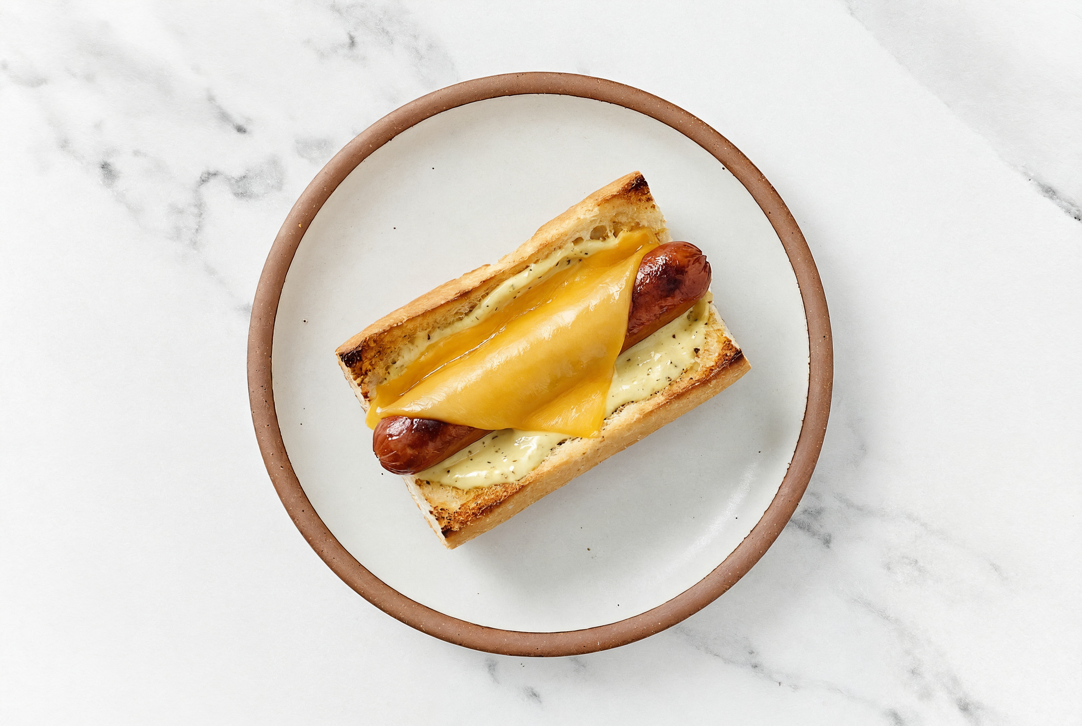 Cheddar Beef Hot Dog with Honey Musard Garlic Sauce on Baguette