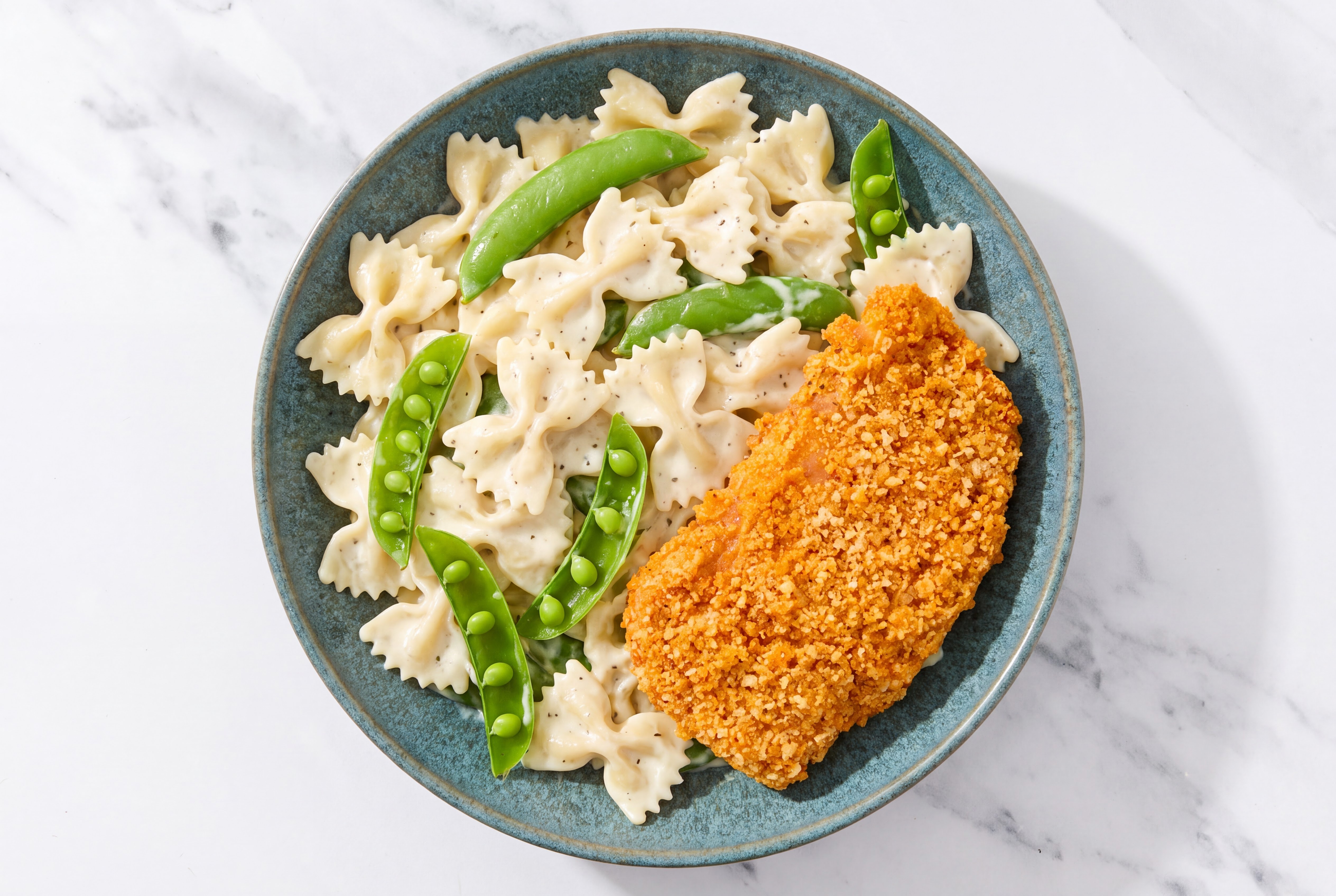 Crispy Hot Honey Chicken over Alfredo Farfalle with Snap Peas