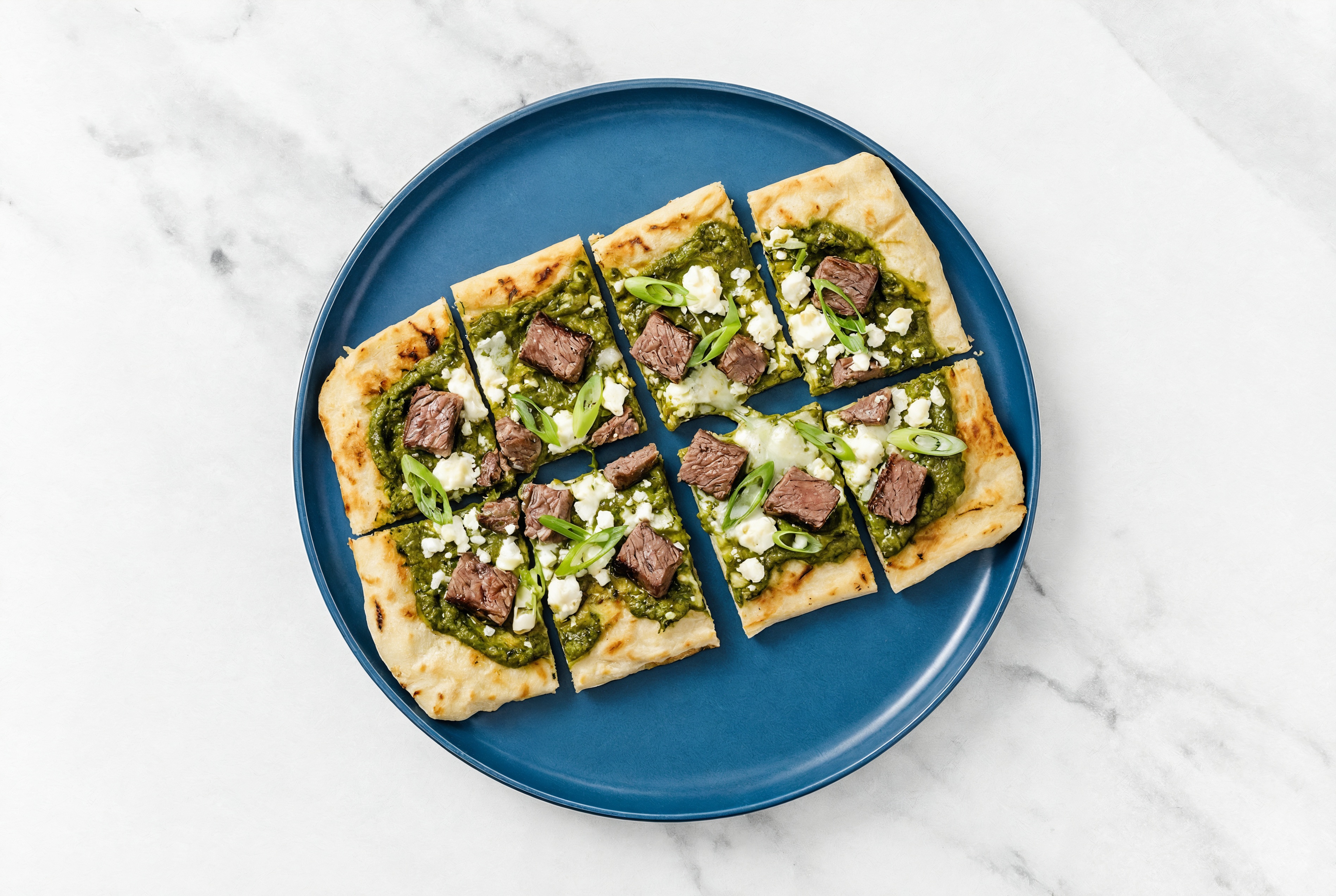 Saag Sauce Wagyu Ribeye Grilled Pizza with Sheep Cheese + Fresh Scallions