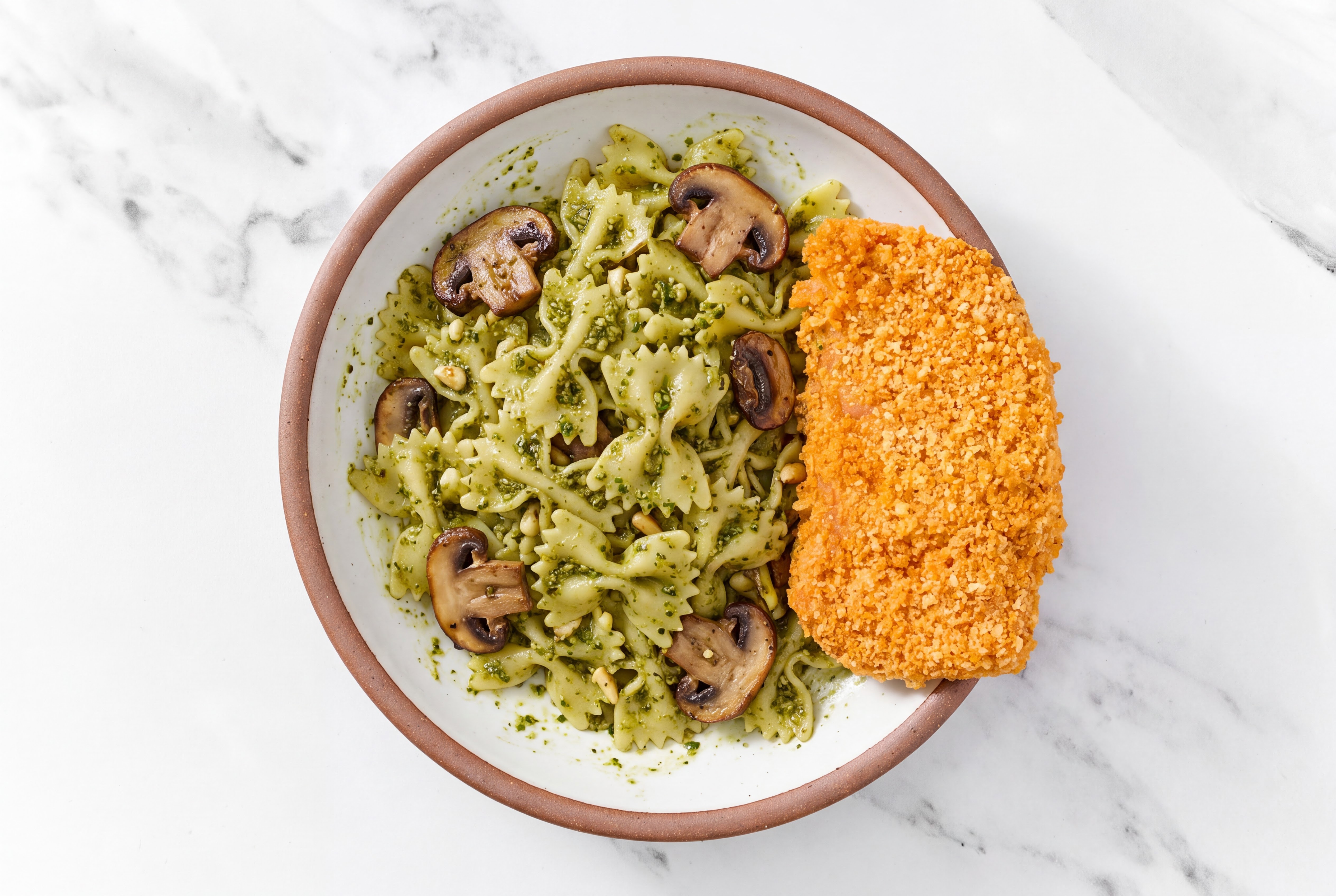 Crispy Hot Honey Chicken over Pesto Farfalle with Baby Bella Mushrooms