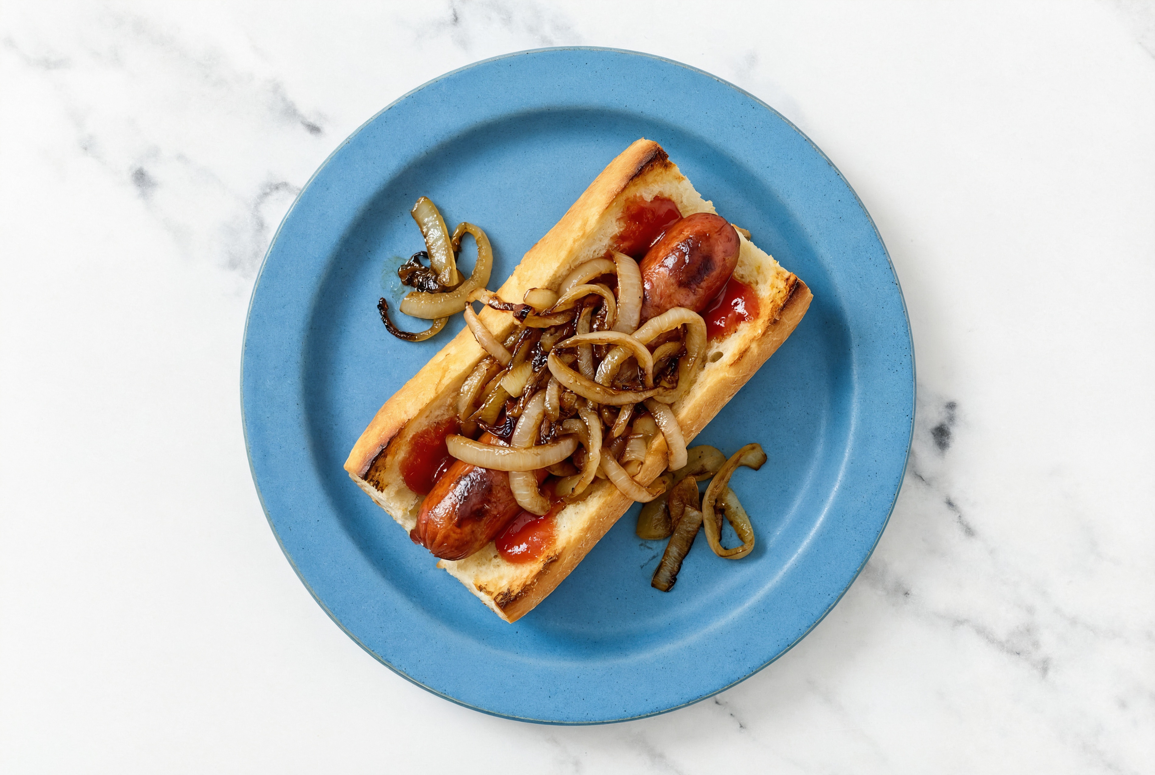Carmelized Onion Beef Hot Dog with Ketchup on Baguette
