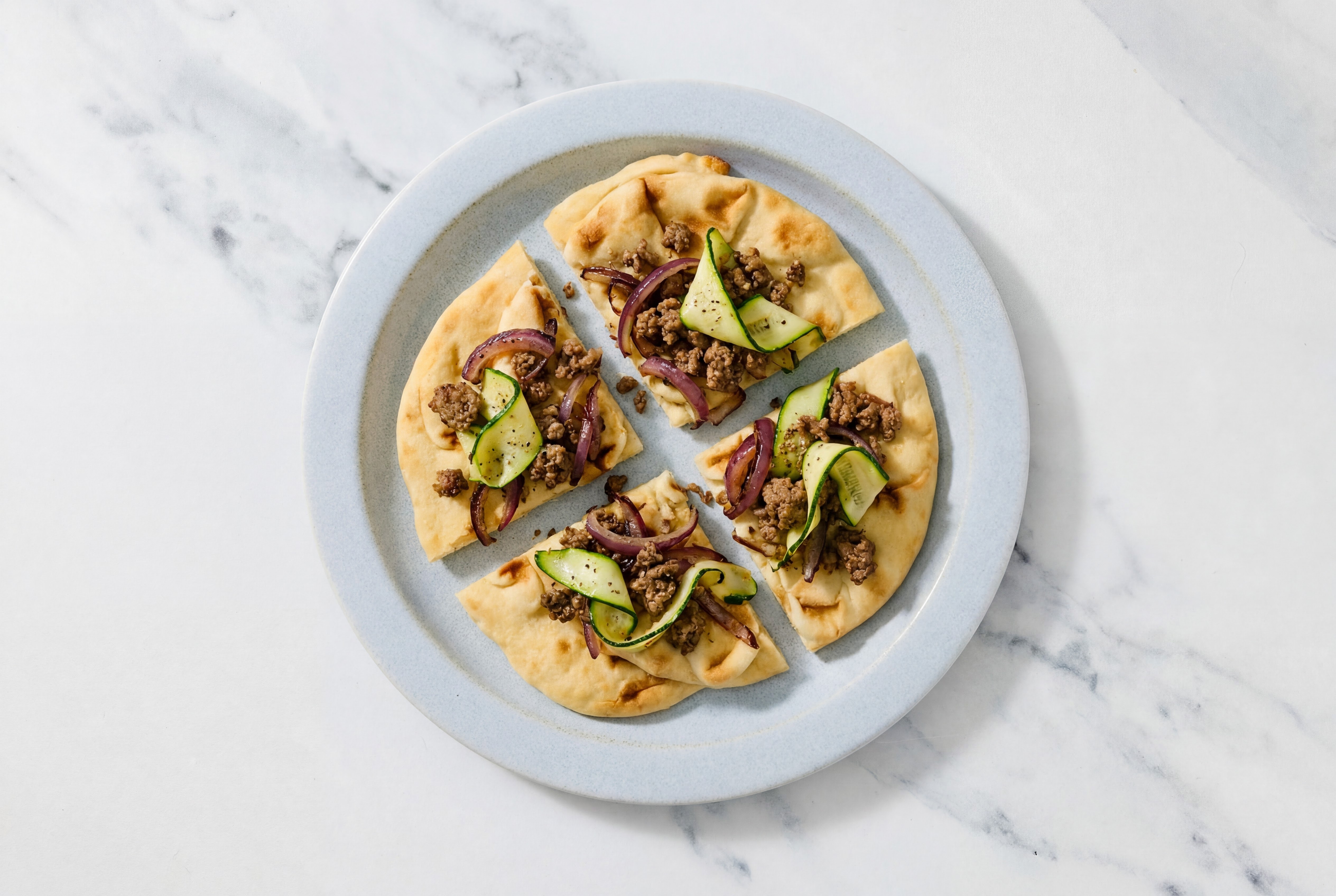 Herby Lamb + Caramelized Onion Naan with Zucchini
