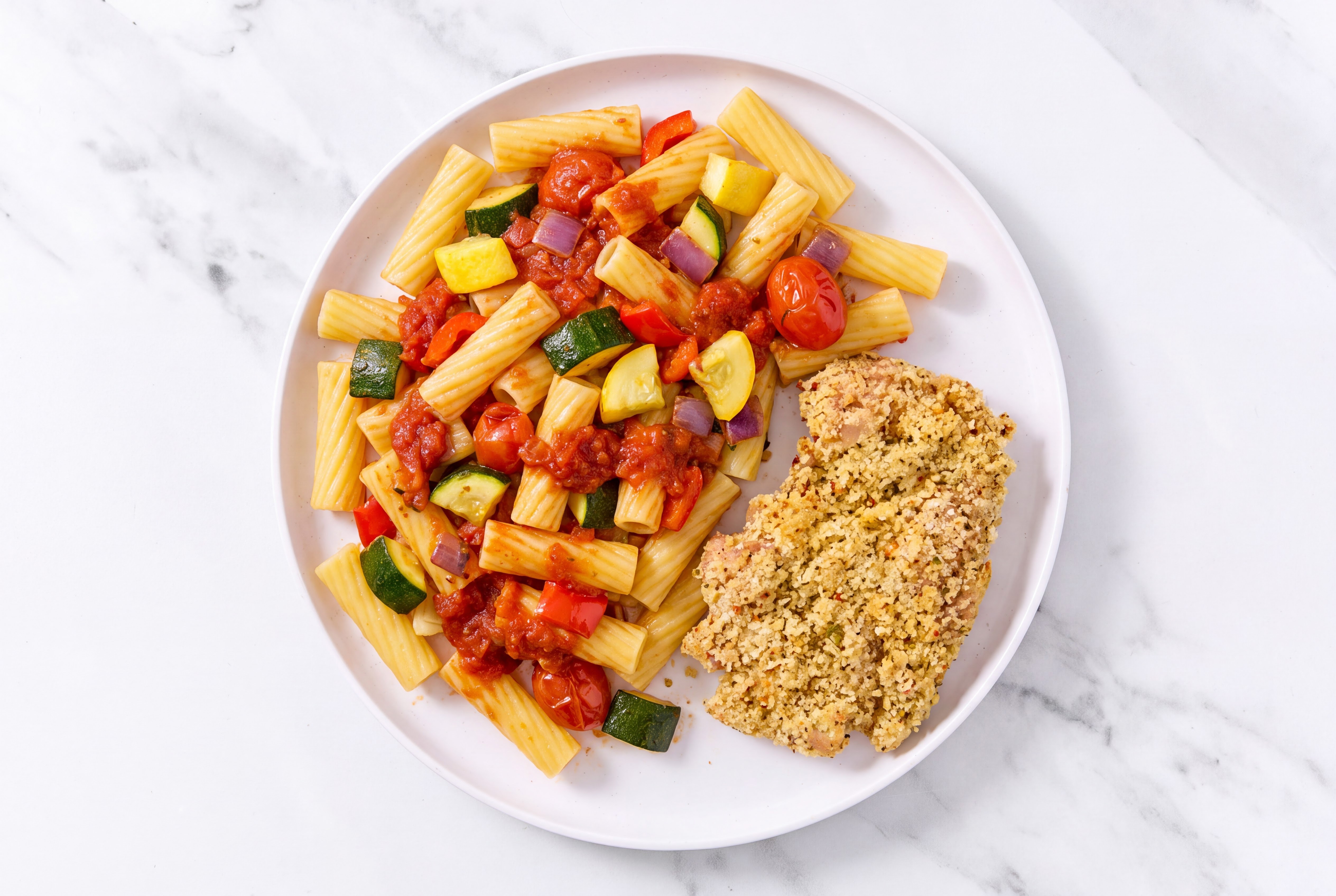 Crispy Garlic Chicken over Marinara Rigatoni with Mixed Veggies