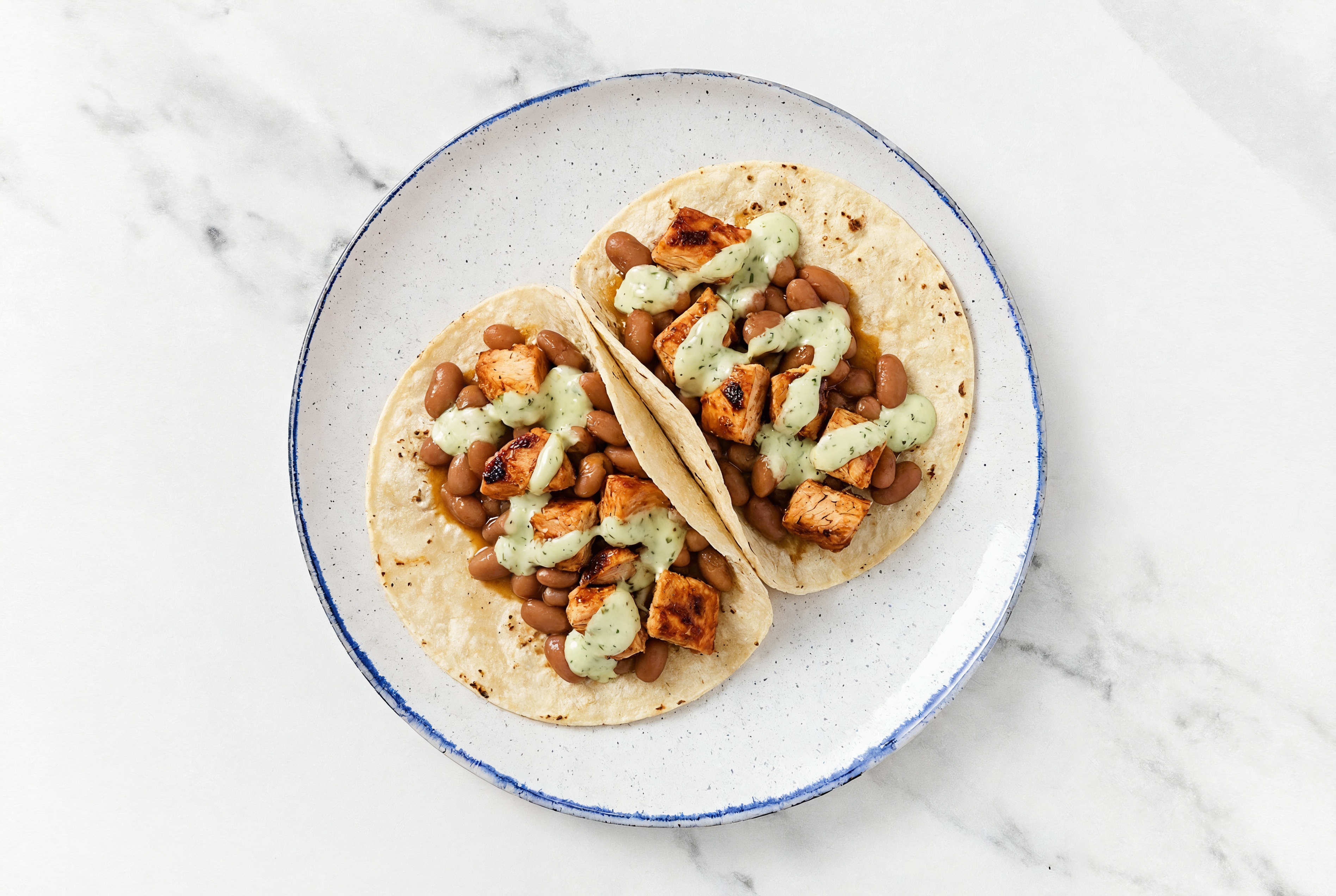 Hearty Chipotle Chicken Tacos with Jalapeño Crema & Pinto Beans