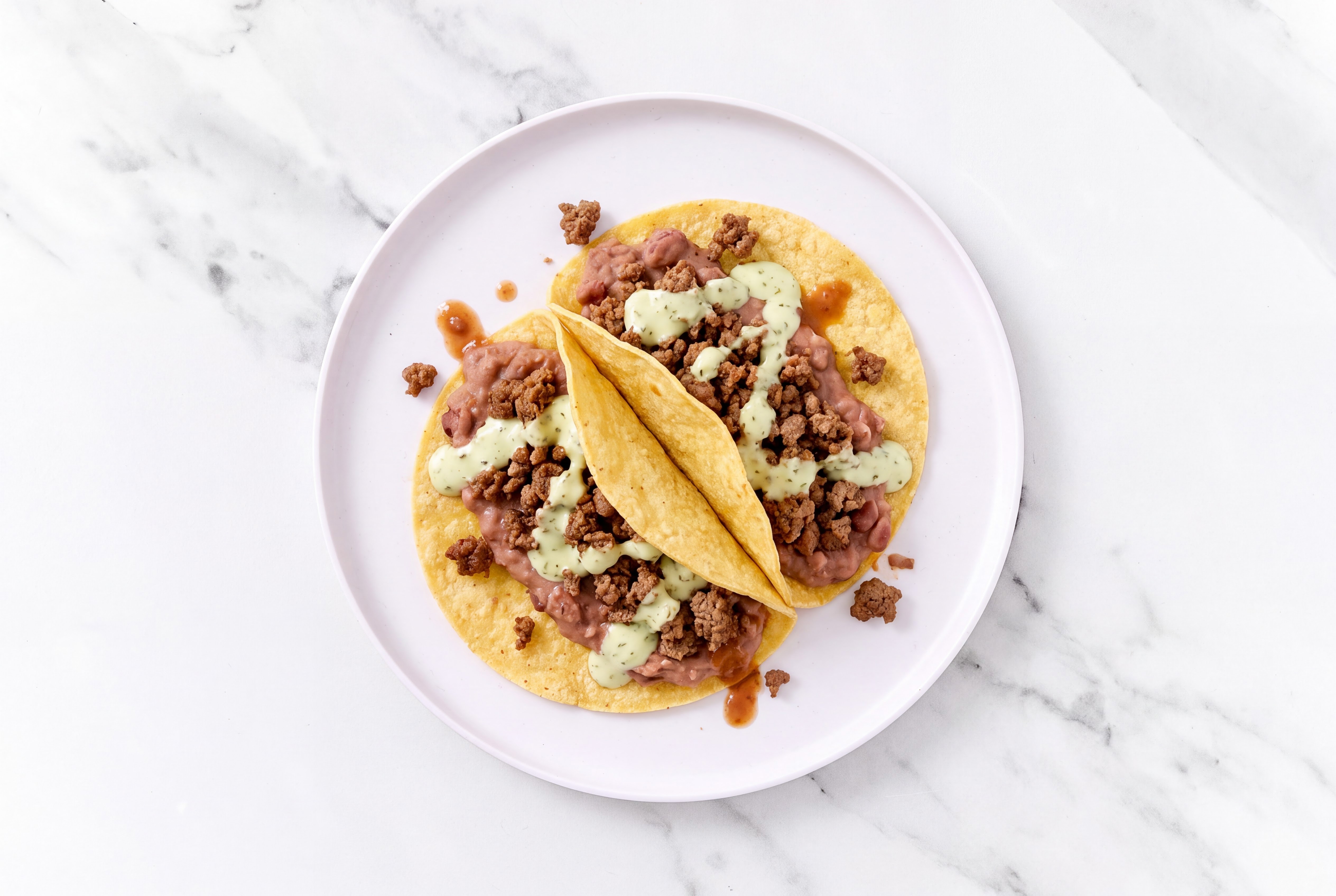 Herby Ground 93/7 Lean Beef Tacos with Jalapeño Crema & Refried Red Beans