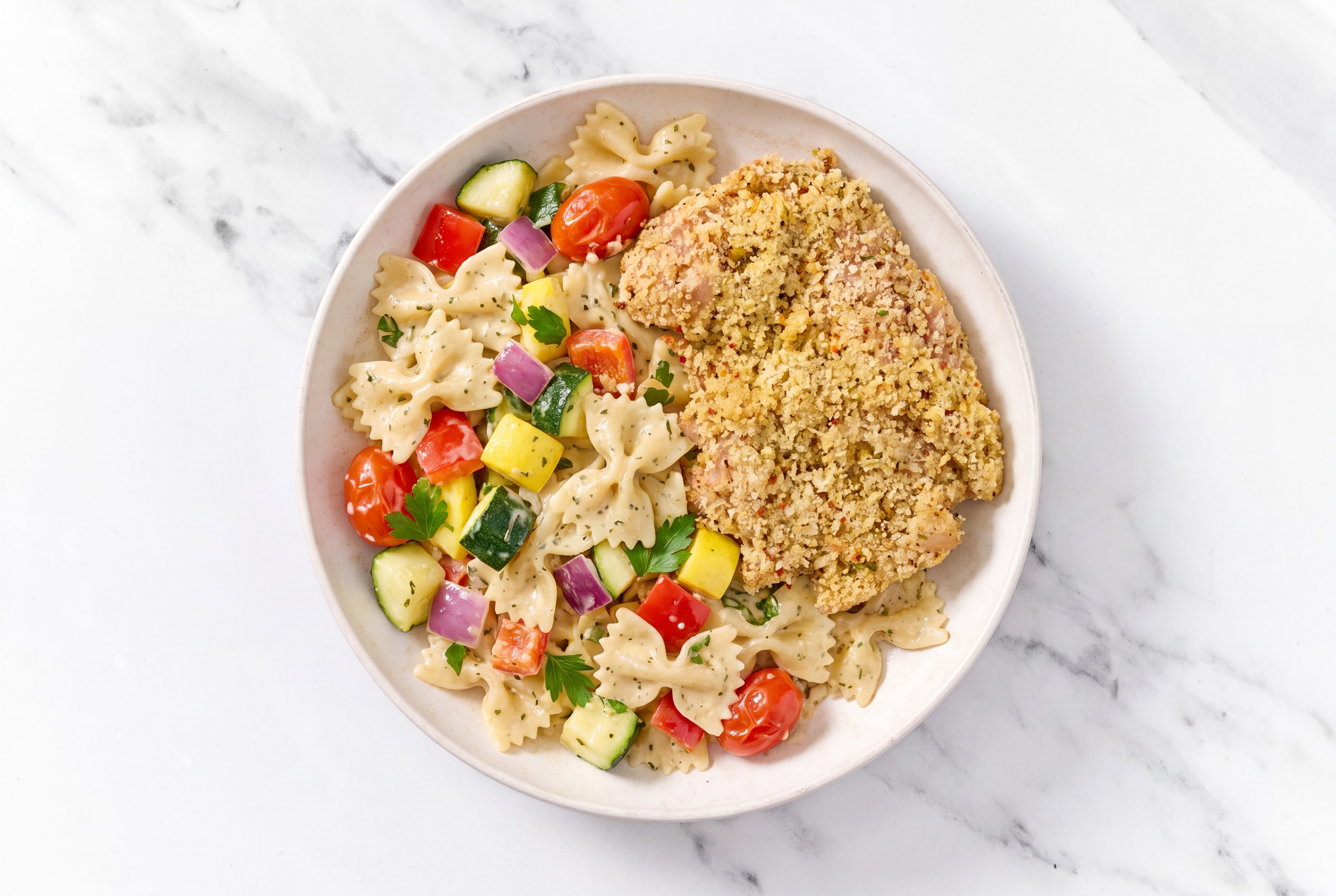 Crispy Garlic Chicken over Creamy Farfalle with Mixed Veggies