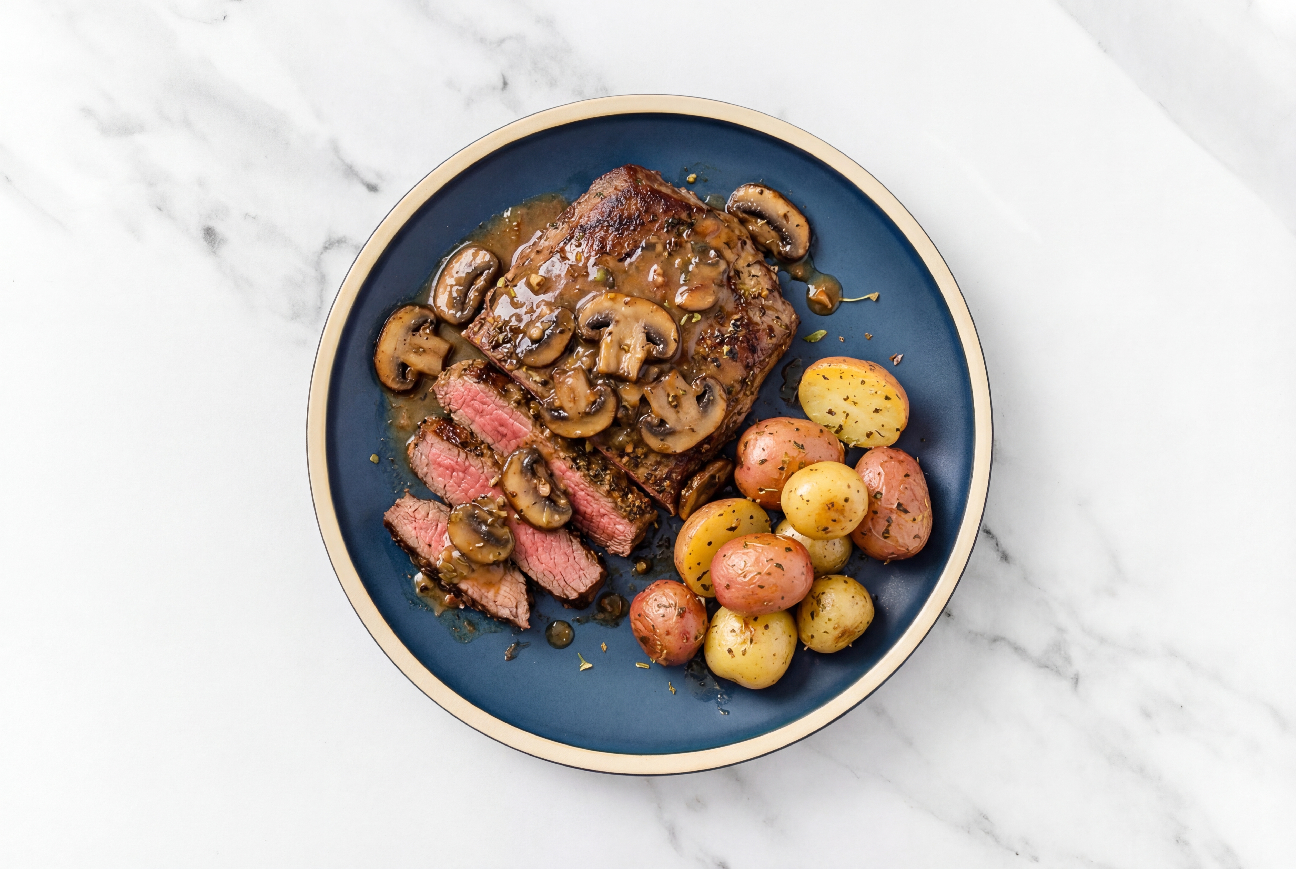 Rosemary Garlic Beef Flank Steak + Multicolored Creamer Potatoes with Mushroom Pan Sauce