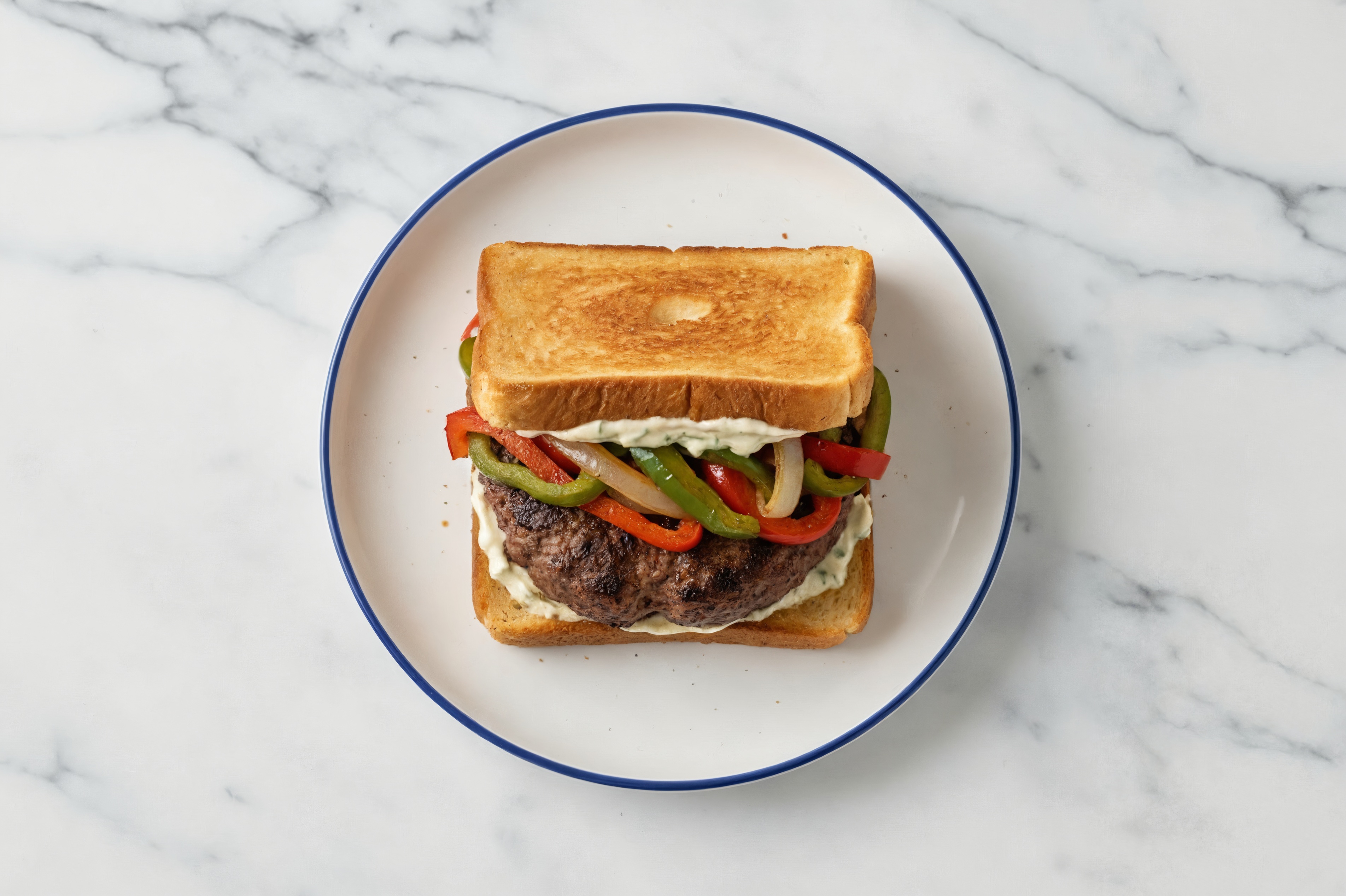 Onion + Pepper Tavern Beef Burger on GF Bread with Garlic Sauce
