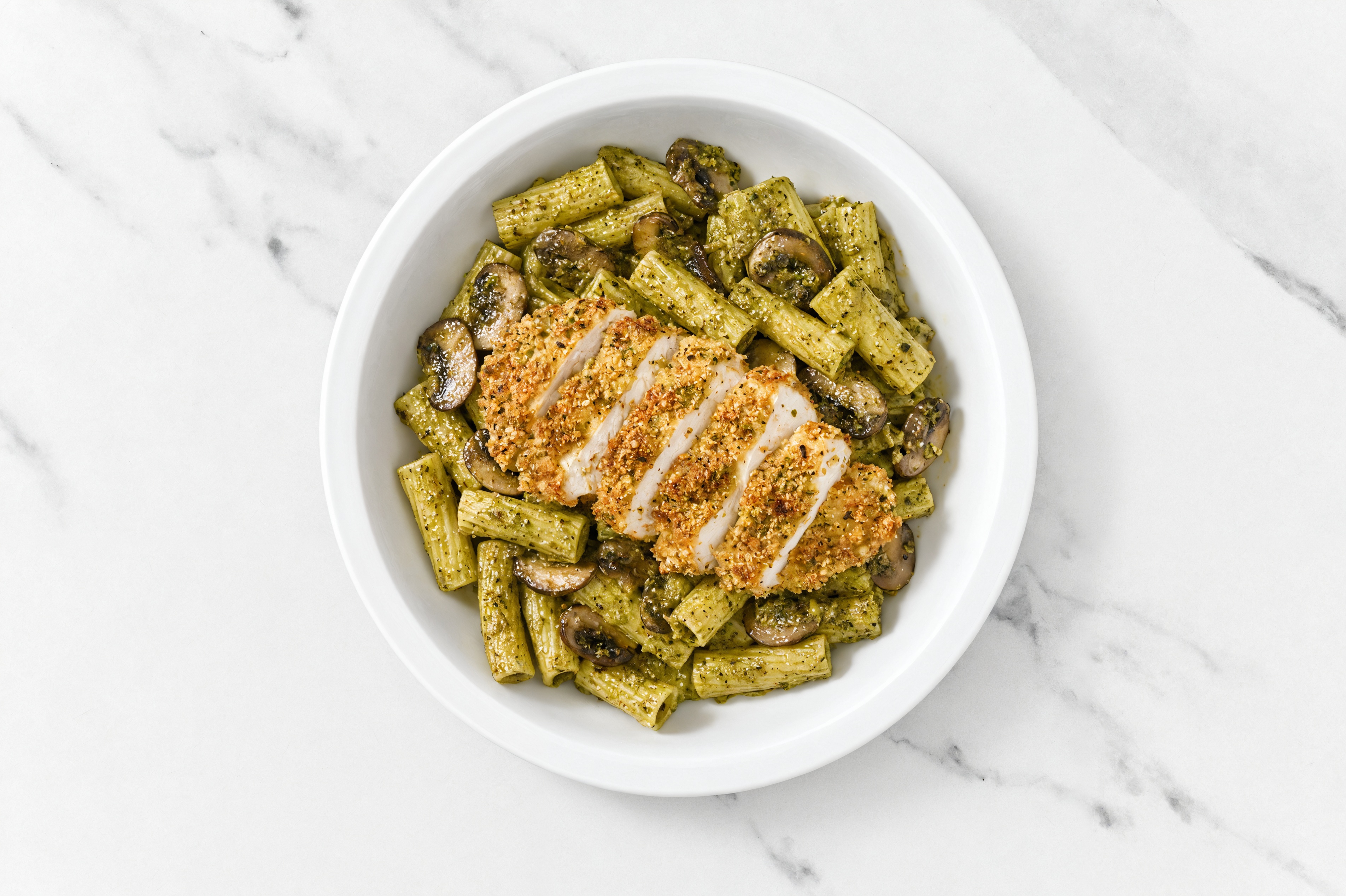 Crispy Garlic Chicken over Pesto Rigatoni with Baby Bella Mushrooms