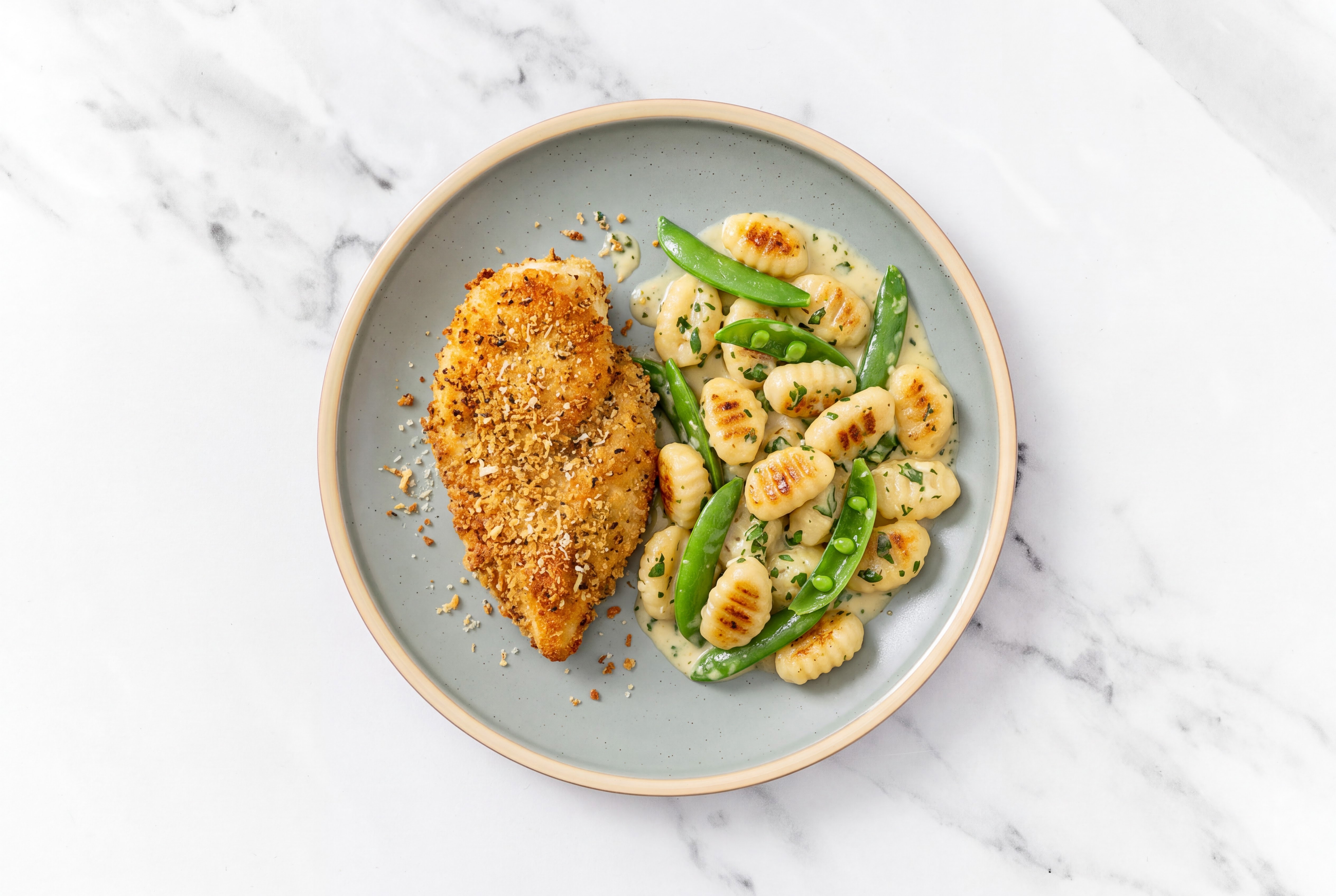Crispy Garlic Chicken over Creamy Gnocchi with Snap Peas