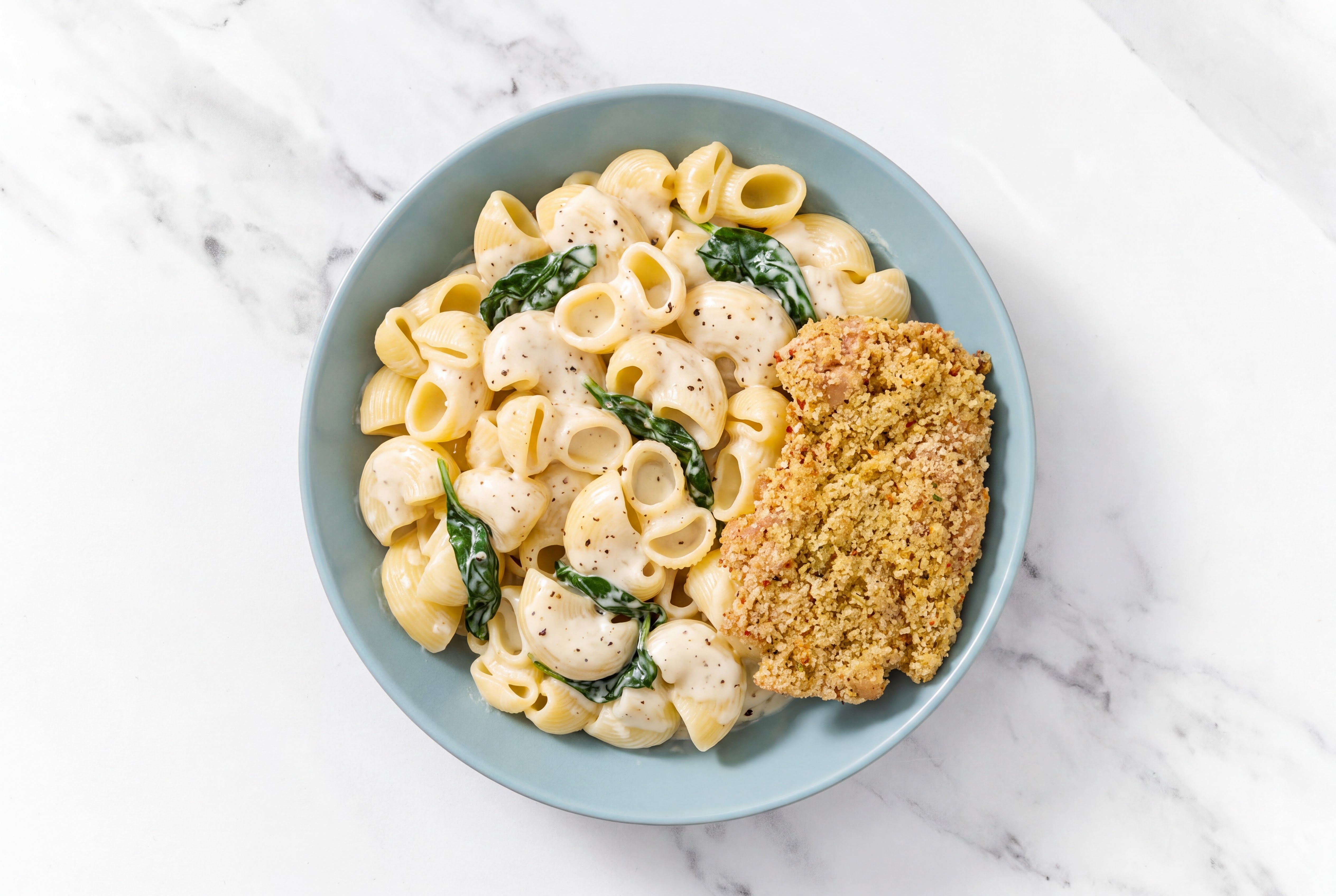 Crispy Garlic Chicken over Alfredo Chiocciole Pasta with Baby Spinach