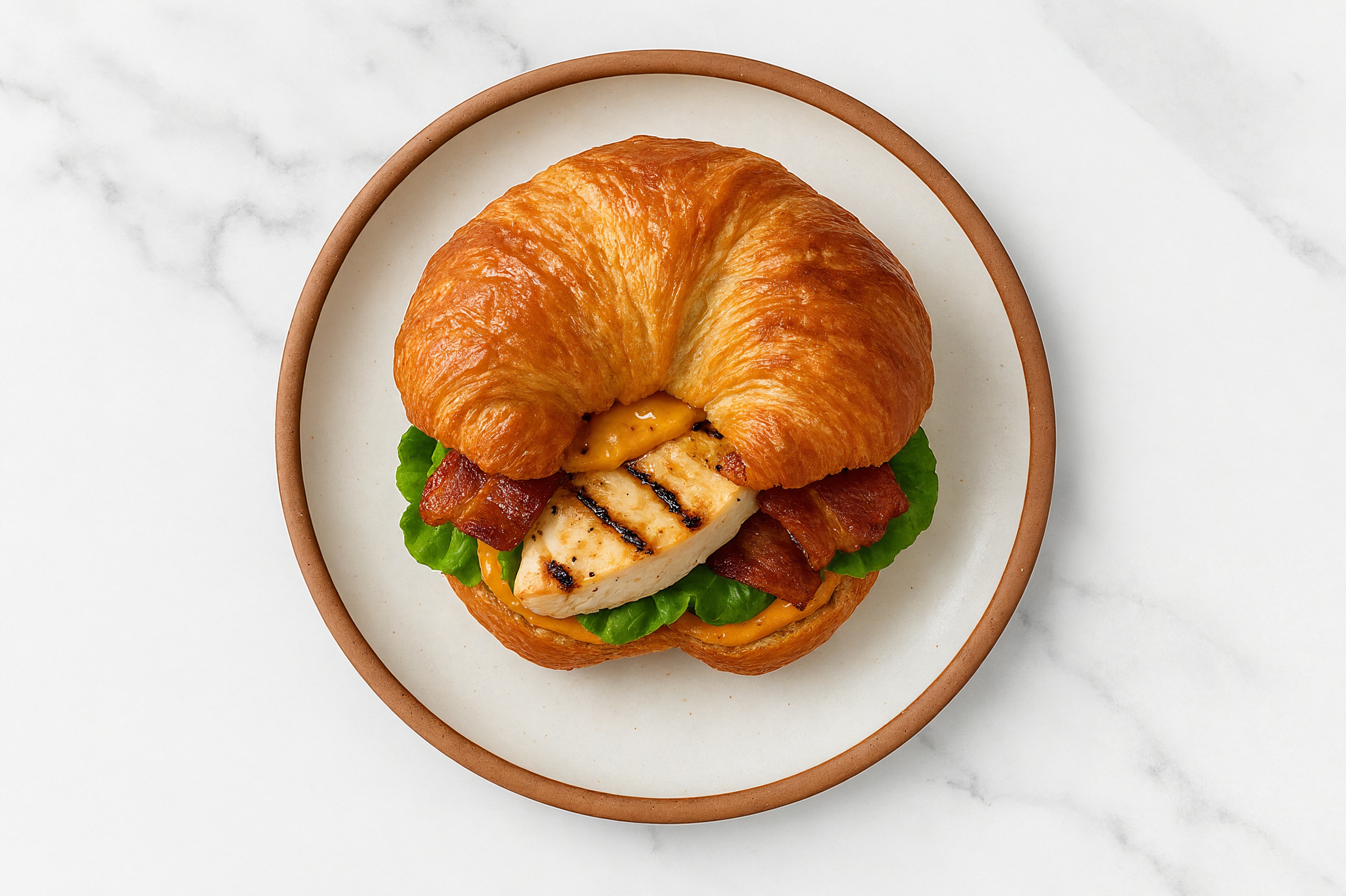 Seasoned Grilled Chicken Breast + Applewood Smoked Pork Bacon on Croissant with Smoky BBQ Garlic Sauce