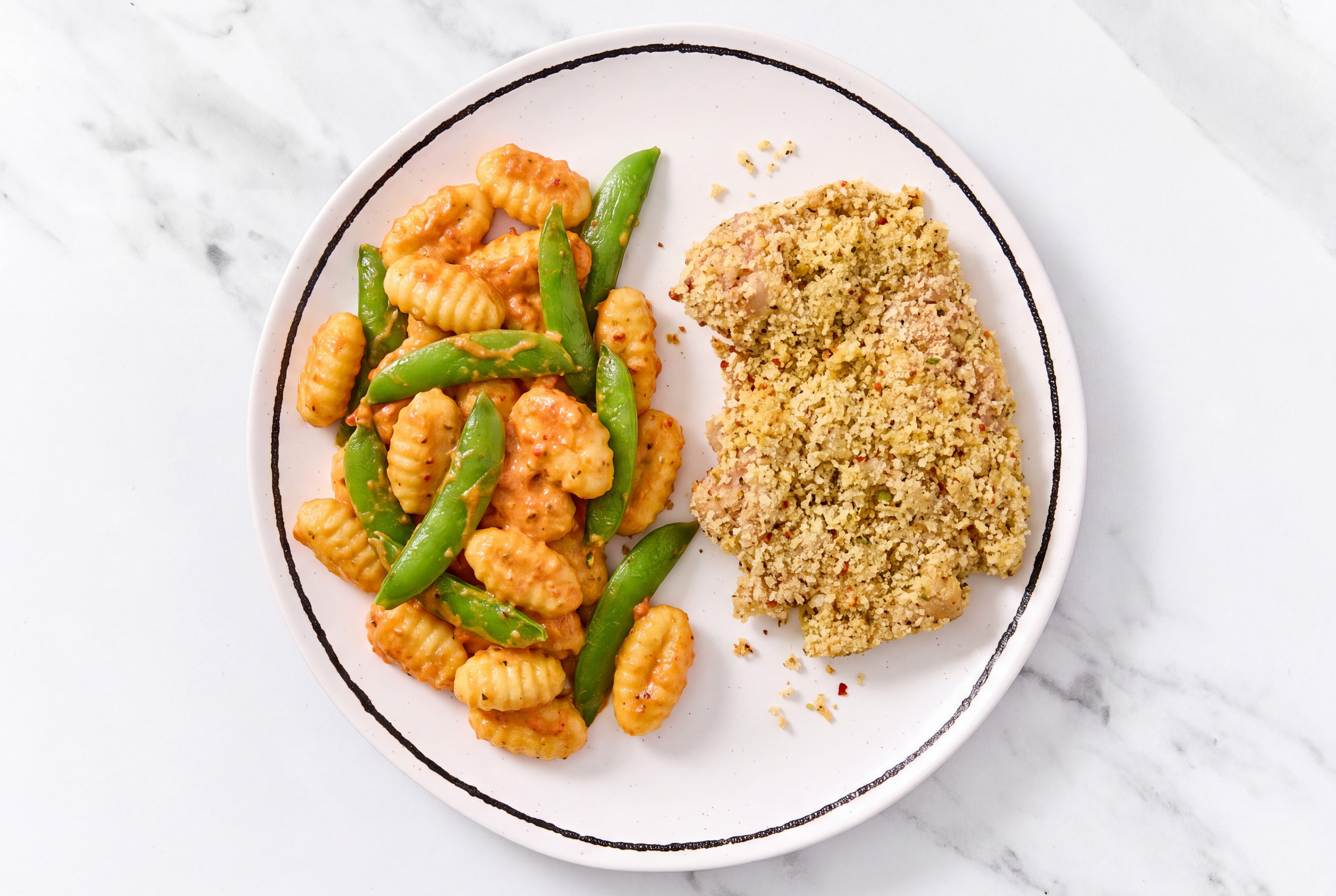 Crispy Garlic Chicken over Creamy Vodka Gnocchi with Snap Peas