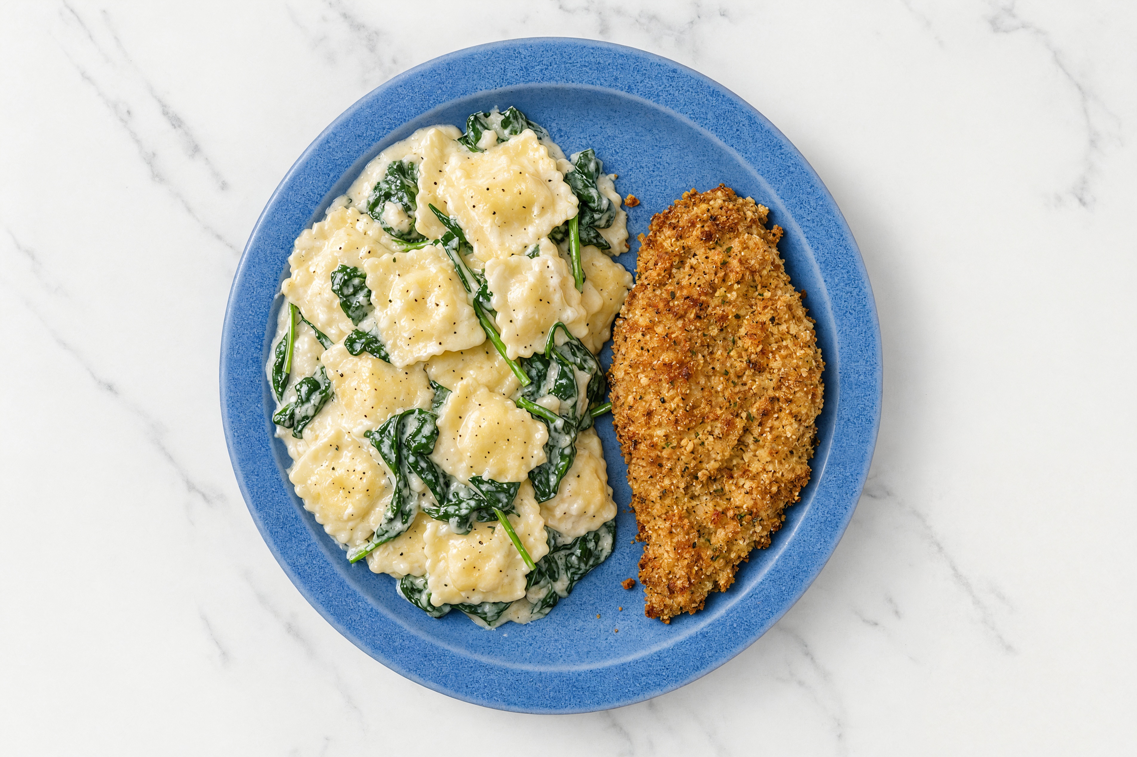 Crispy Garlic Chicken over Alfredo Ravioli with Baby Spinach