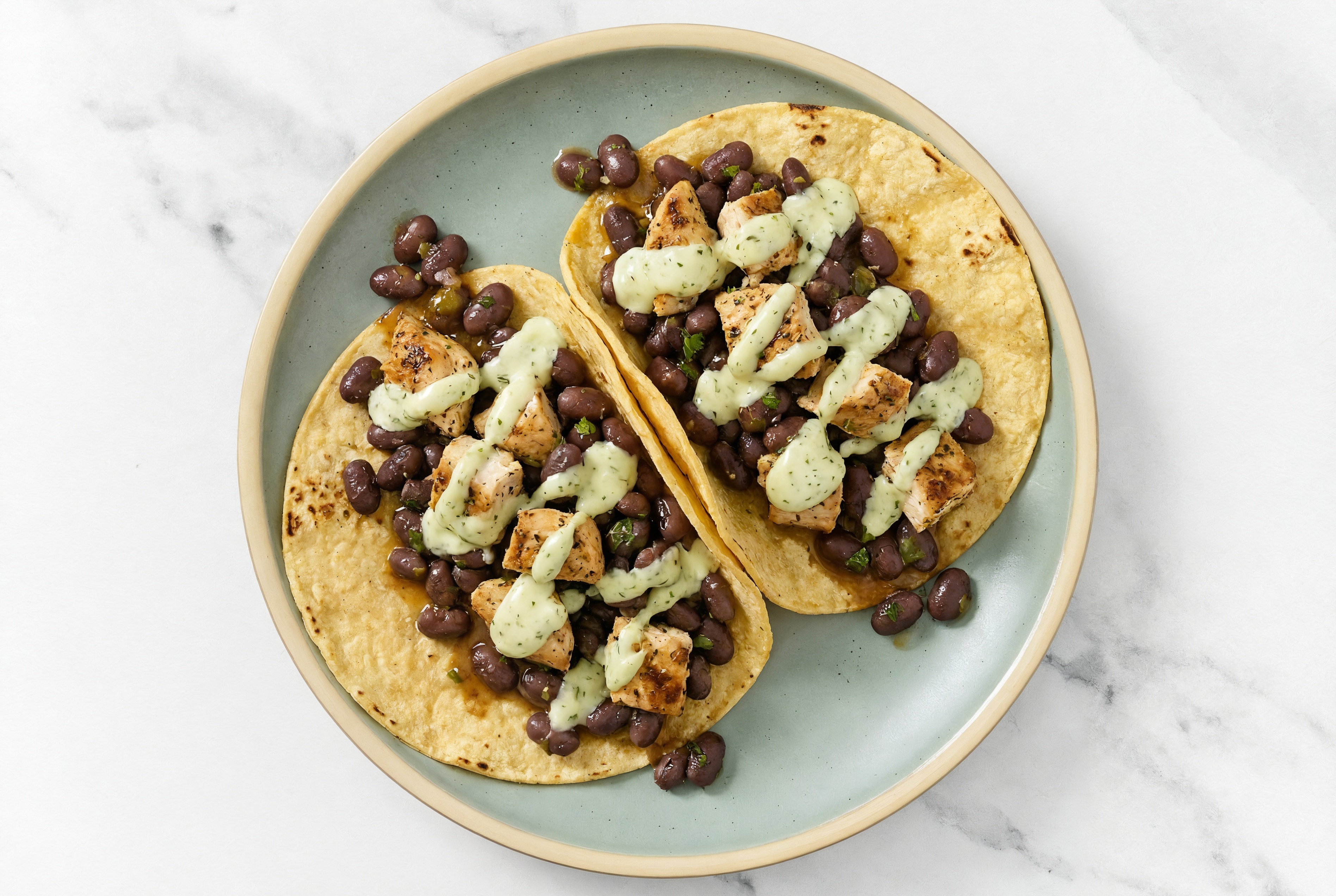 Herby Garlic Chicken Tacos with Jalapeño Crema & Spiced Beans