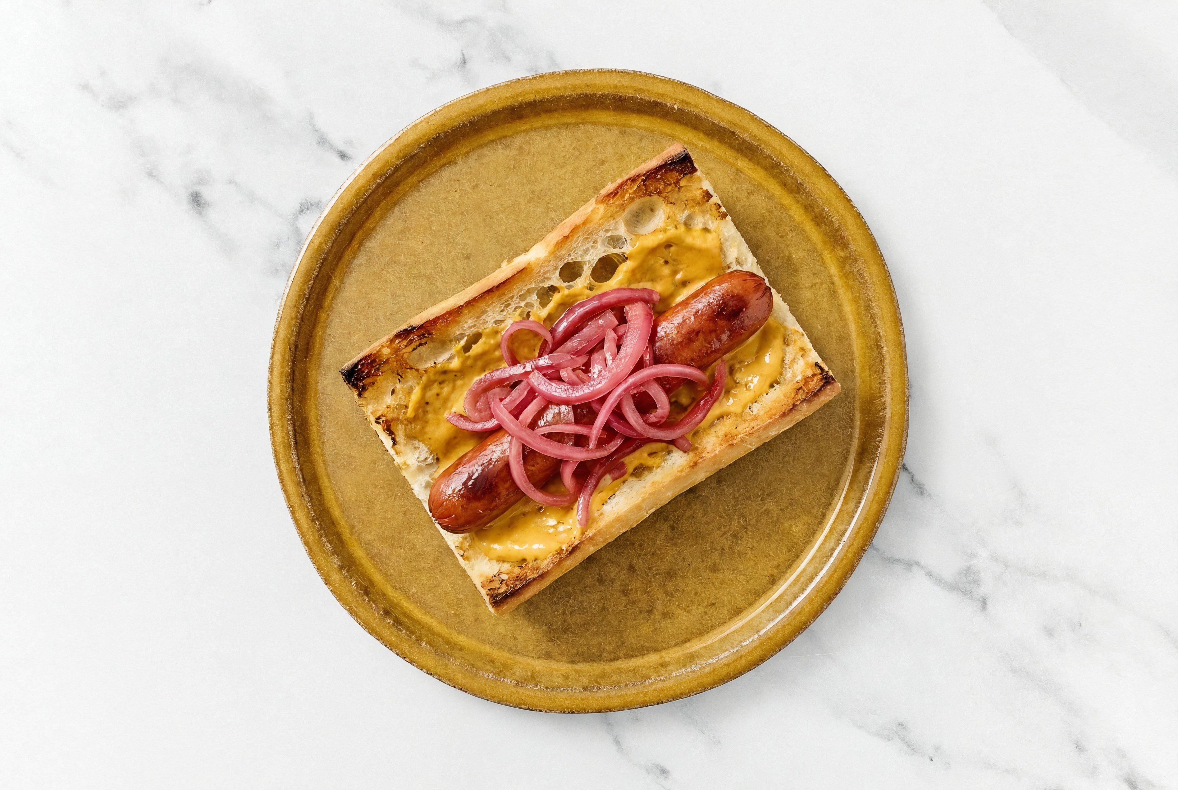 Pickled Red Onion Beef Hot Dog with Super Special Sauce on Baguette