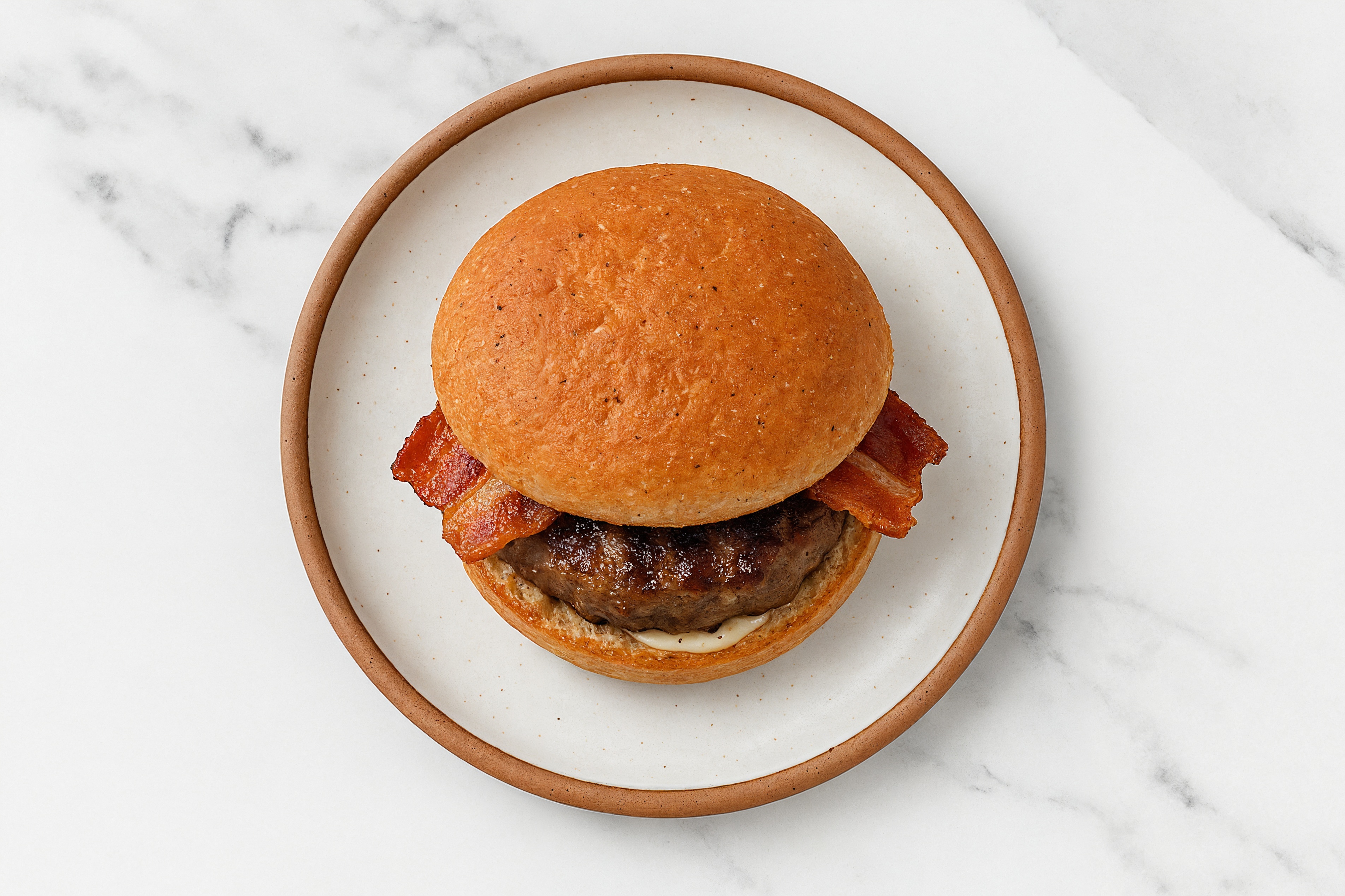 Lamb Burger on Sprouted Grain with Tzatziki & Applewood Smoked Pork Bacon