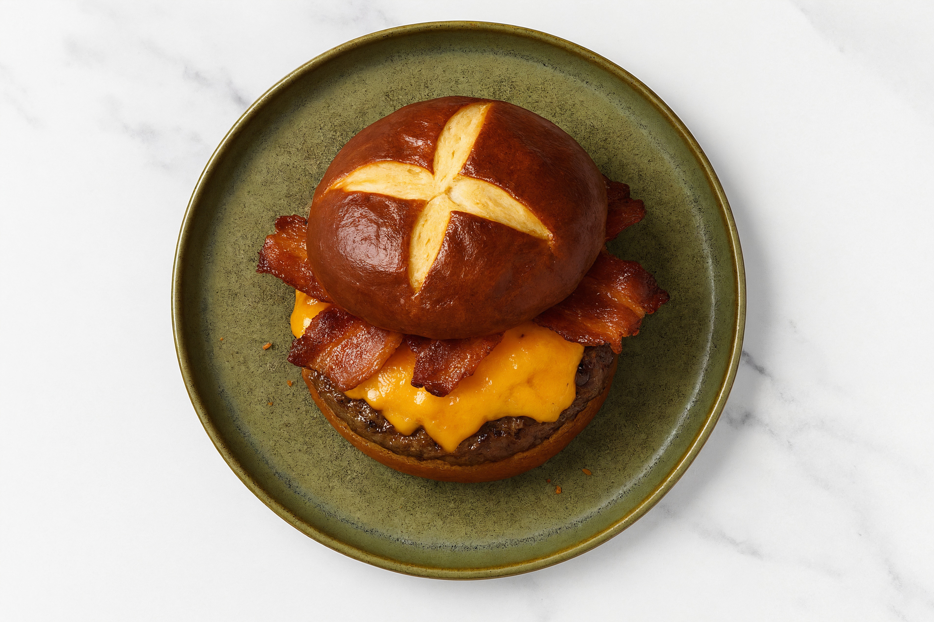 Juicy Applewood Smoked Pork Bacon Cheeseburger on Pretzel Bun