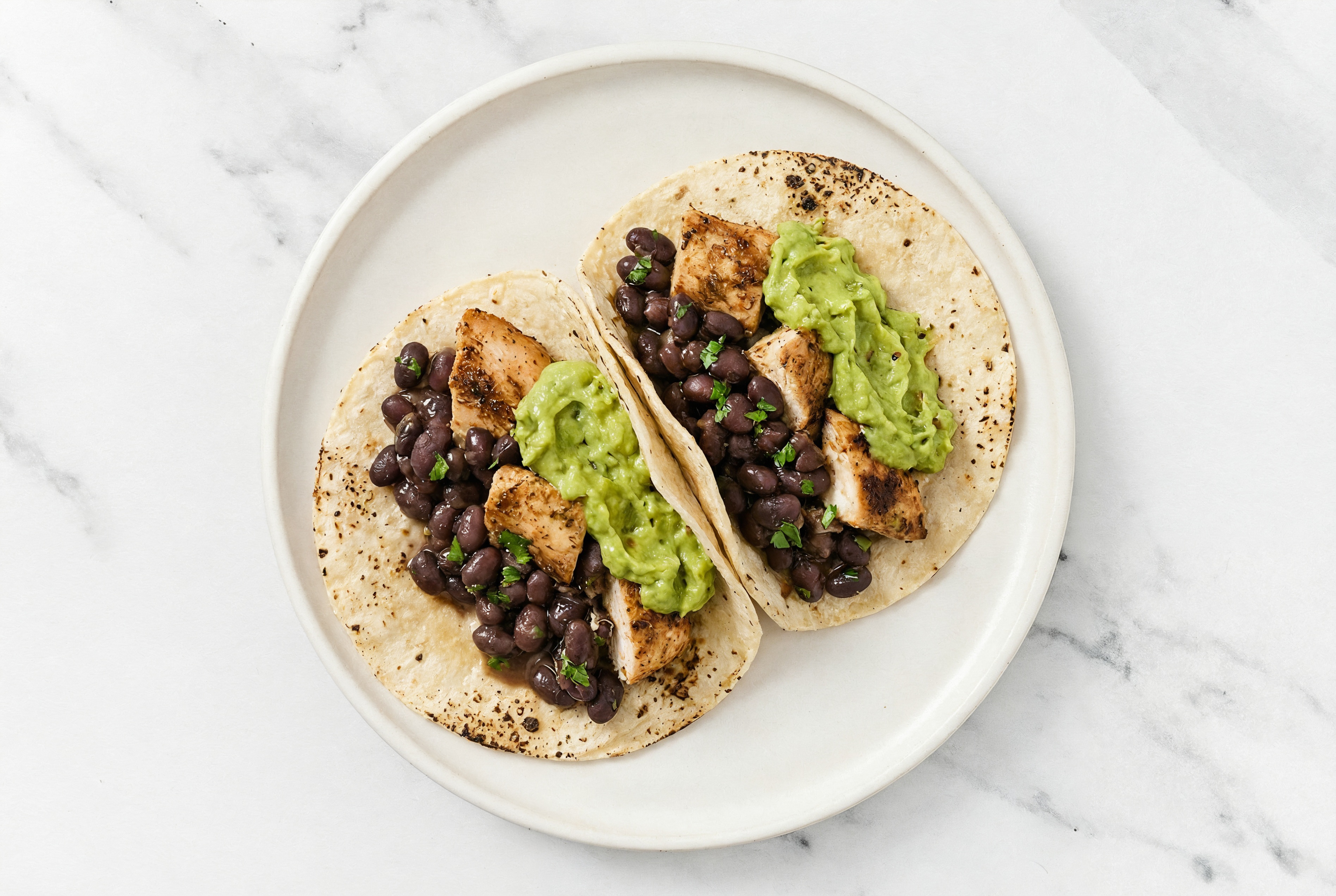 Hearty Garlic Chicken Tacos with Guacamole & Spiced Beans