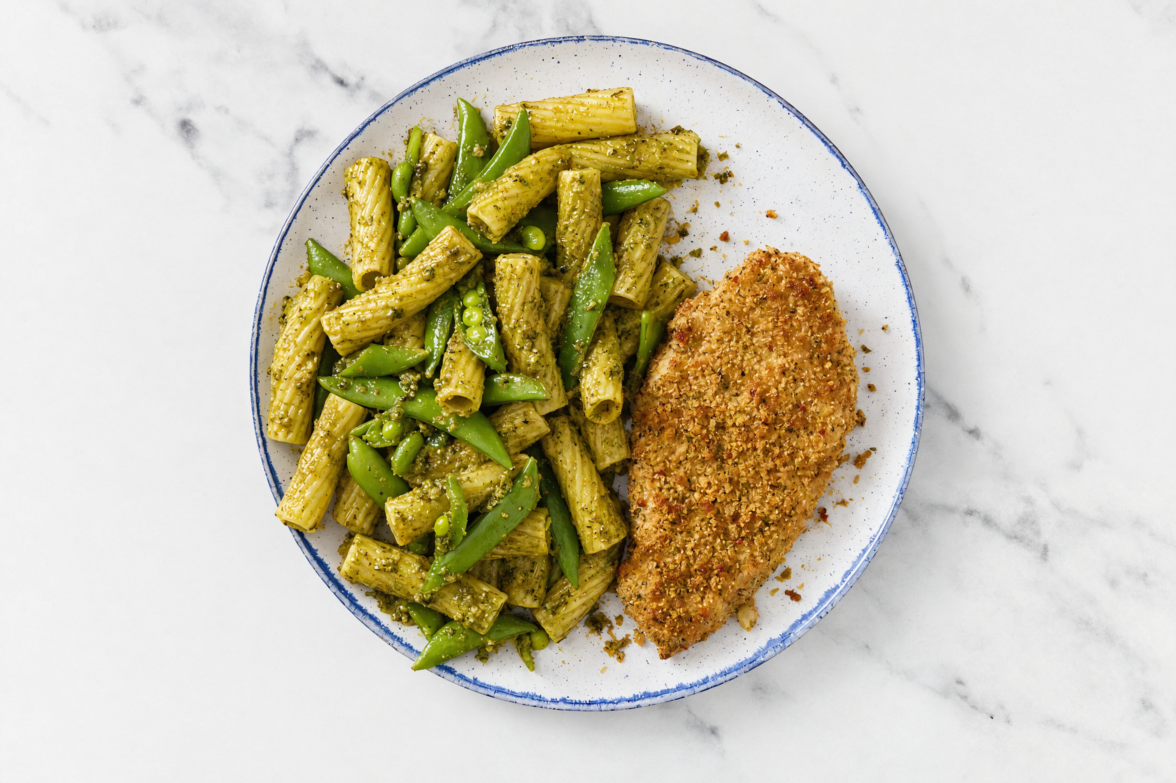 Crispy Garlic Chicken over Pesto Rigatoni with Snap Peas