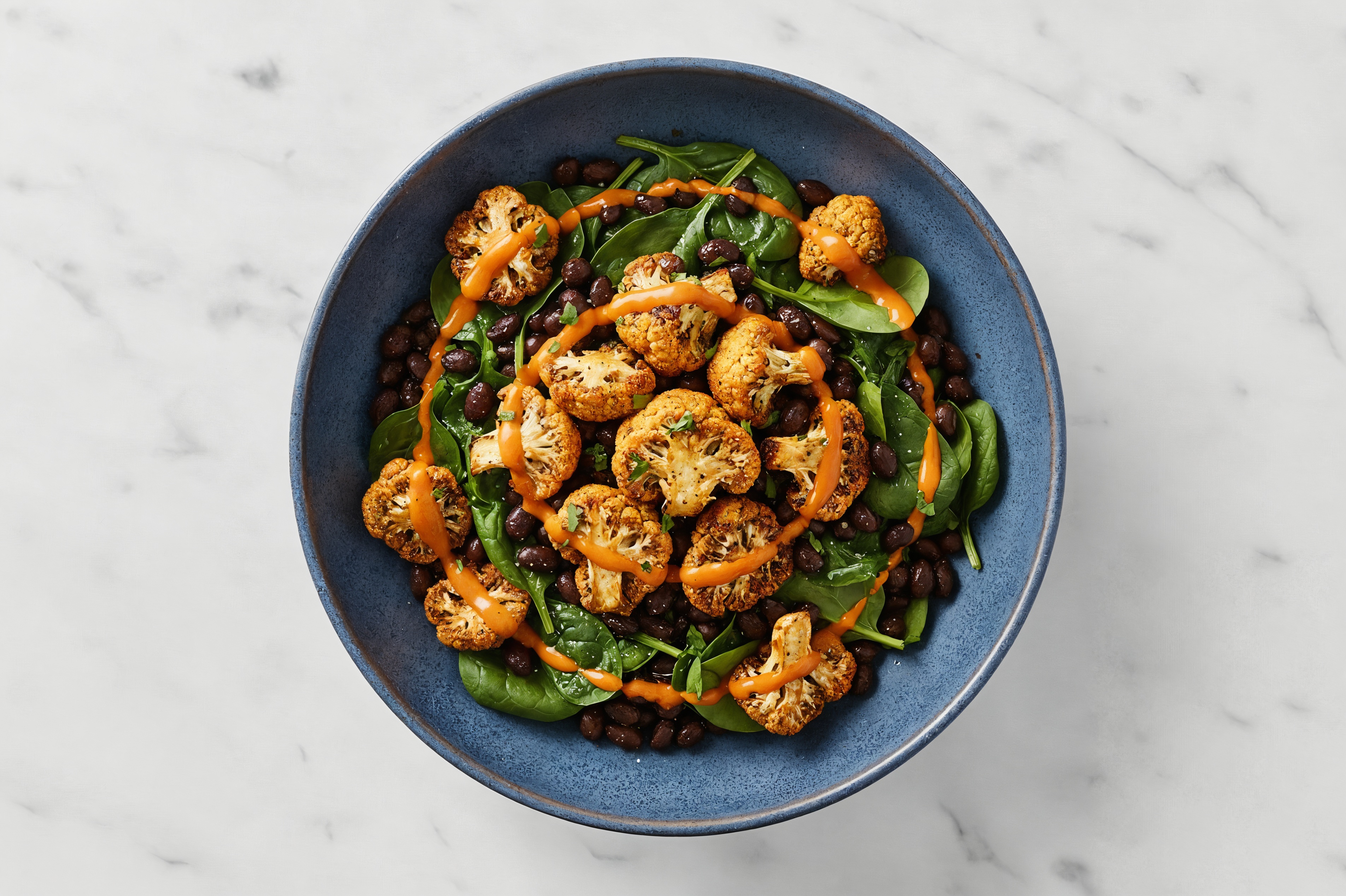 Buffalo Cauliflower with Organic Spinach + Cuban Spiced Black Beans