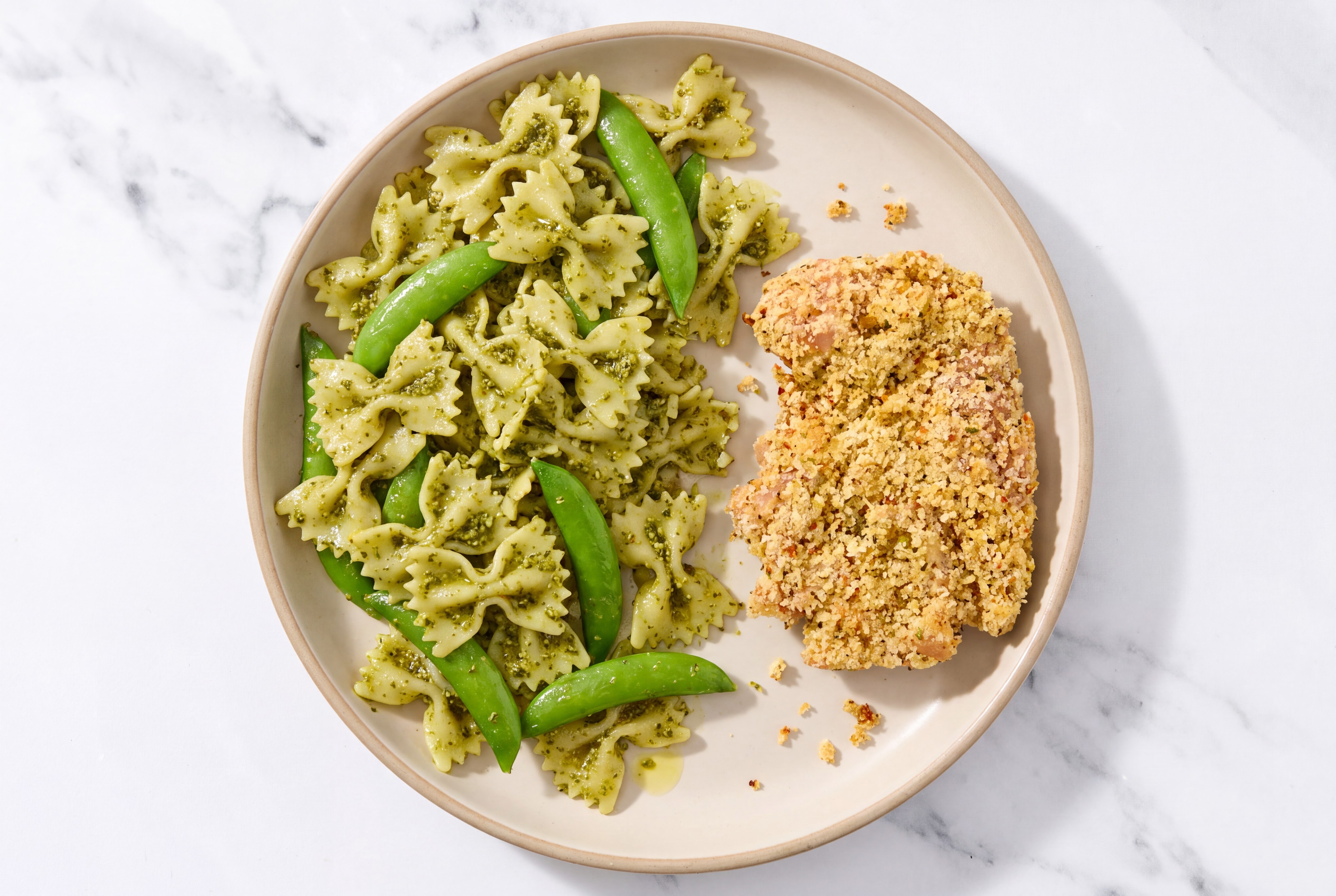 Crispy Garlic Chicken over Pesto Farfalle with Snap Peas