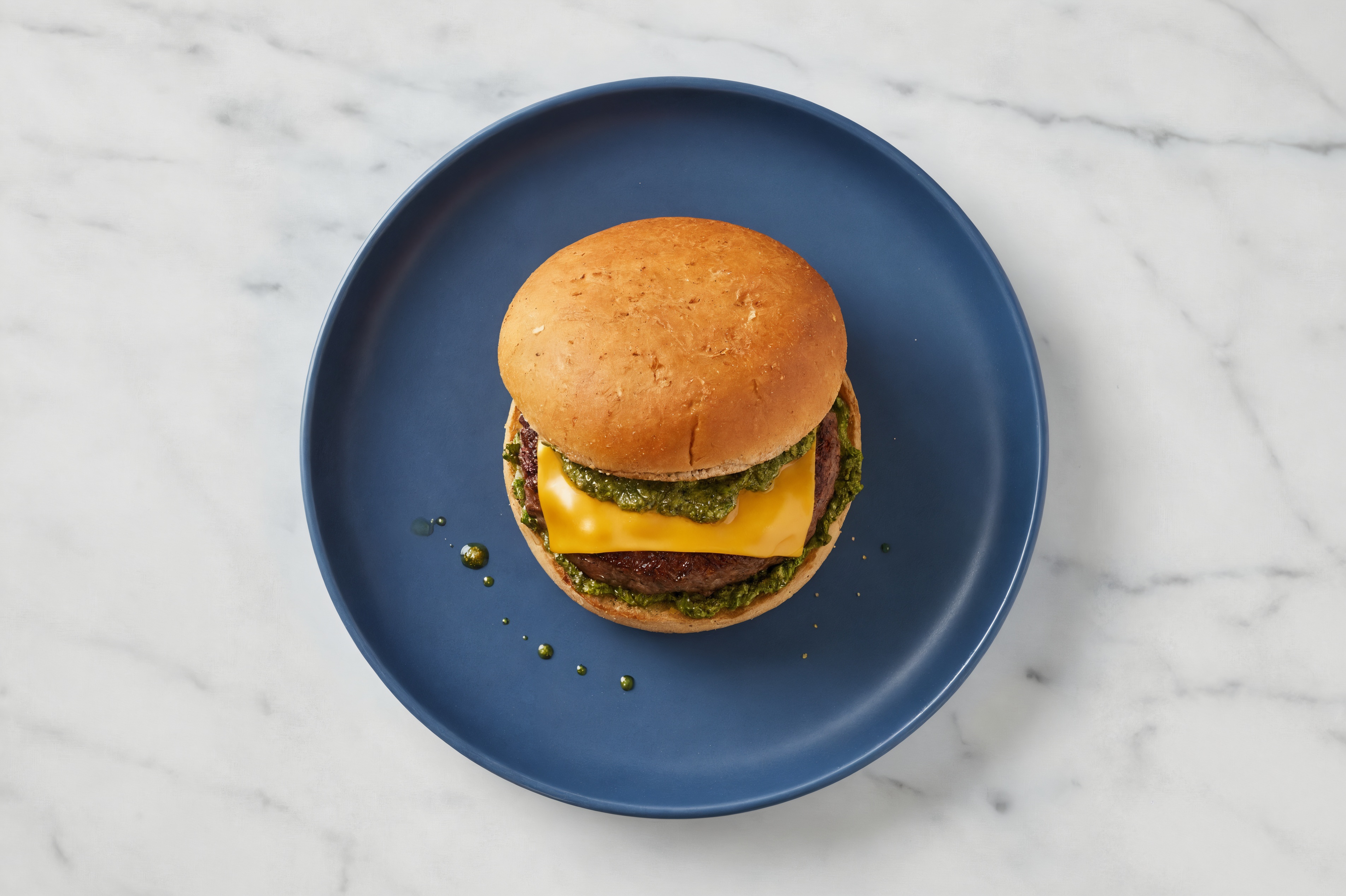 Ground Lamb Burger on Sprouted Grain with Spinach Pesto & American