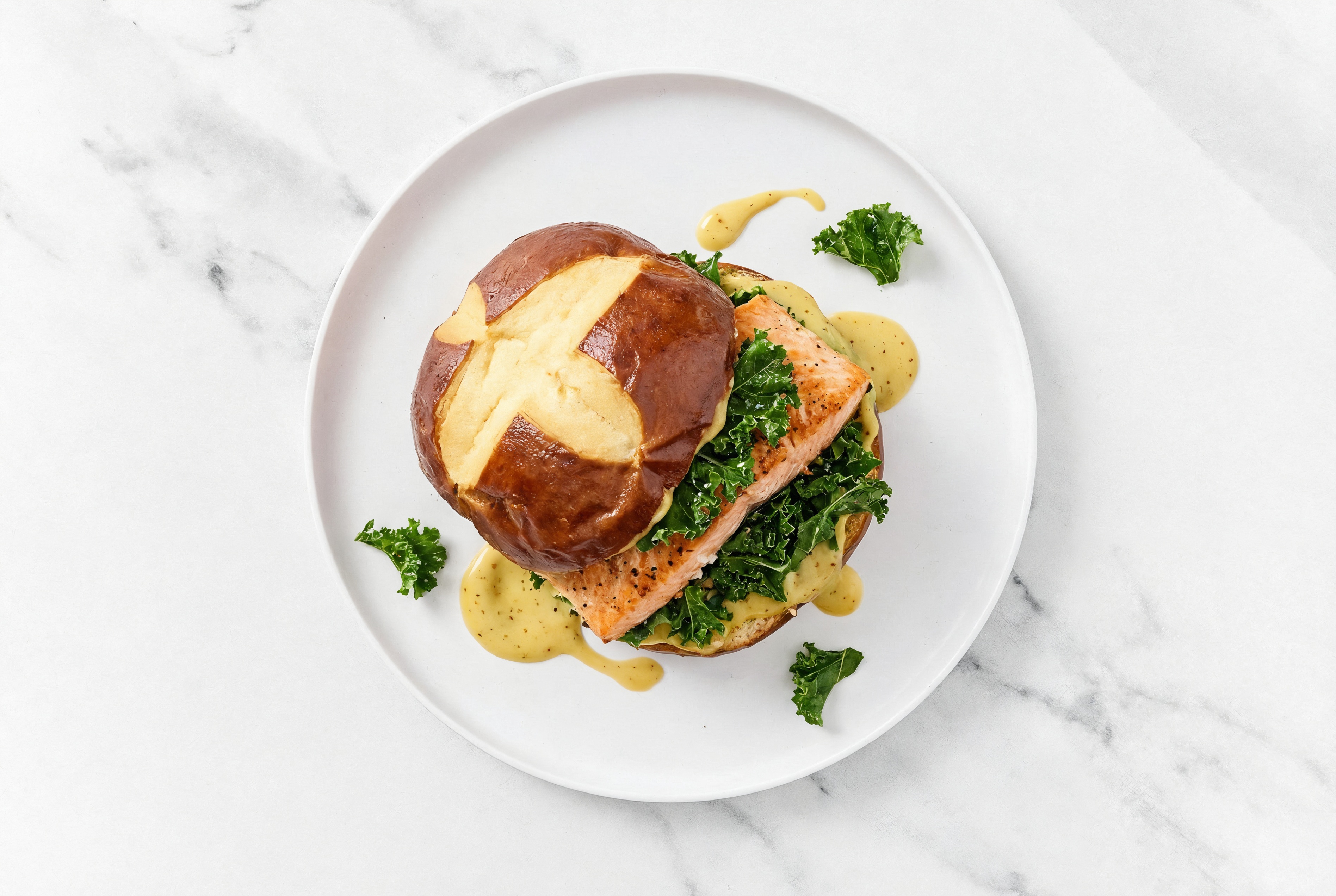 Honey Mustard Salmon Sandwich on Pretzel Bun with Kale