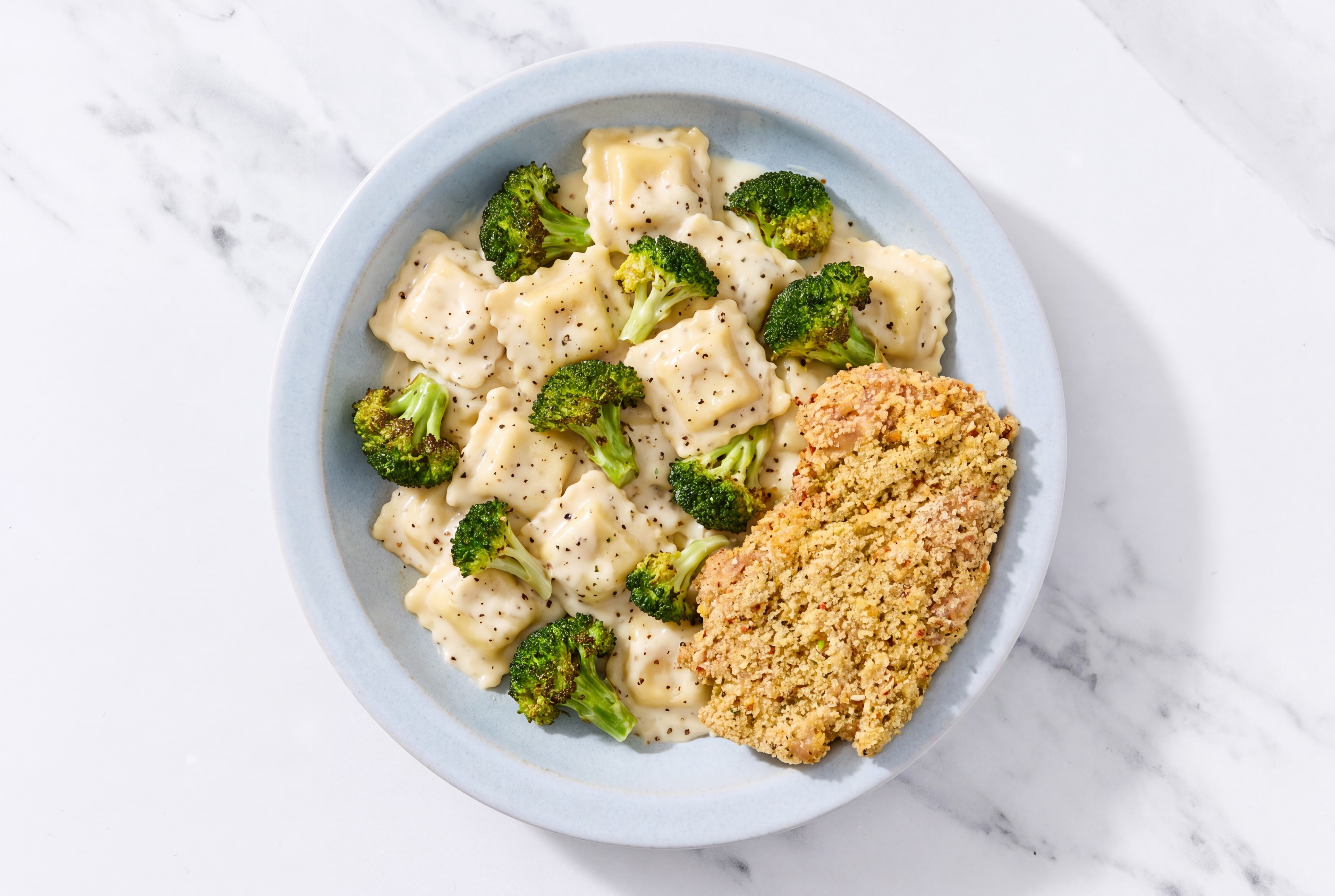 Crispy Garlic Chicken over Alfredo Ravioli with Broccoli