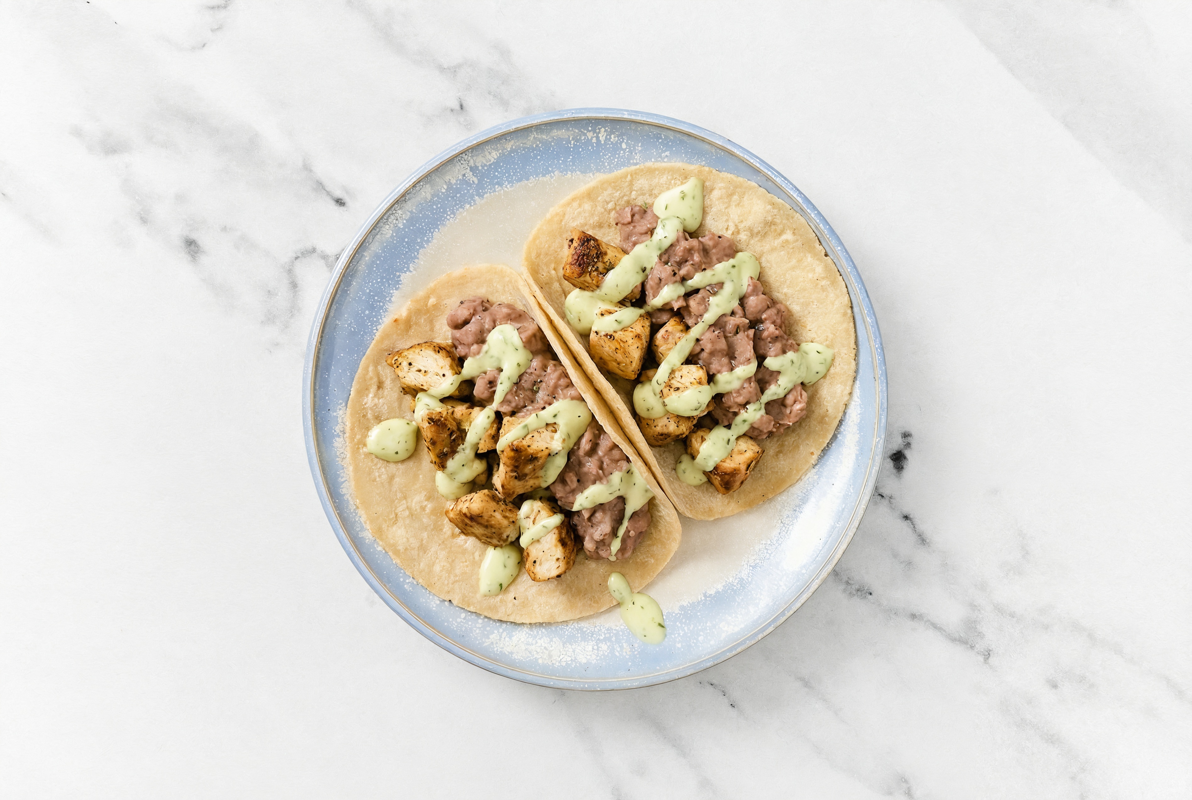 Garlic Chicken Tacos with Jalapeño Crema & Refried Red Beans