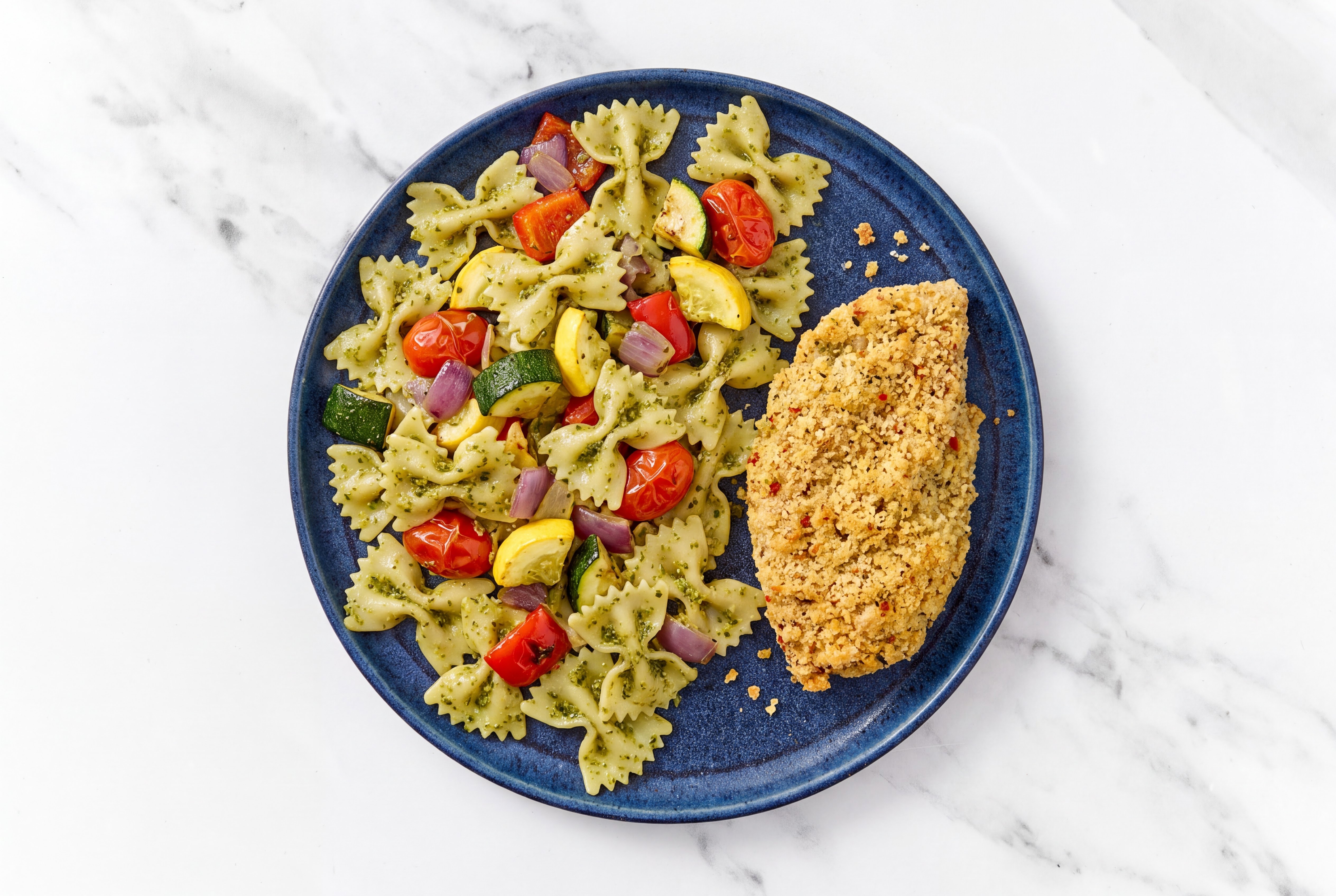Crispy Garlic Chicken over Pesto Farfalle with Mixed Veggies